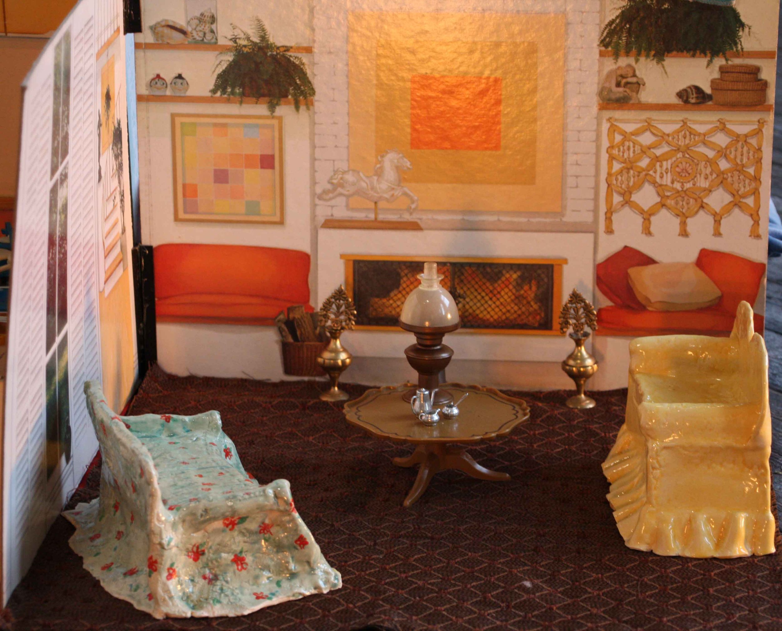 A cozy living room with a brick fireplace, a wall with abstract art, decorative shelves with plants and ceramics, vintage furniture including a floral sofa and carved chairs, a coffee table, and various decorative items.