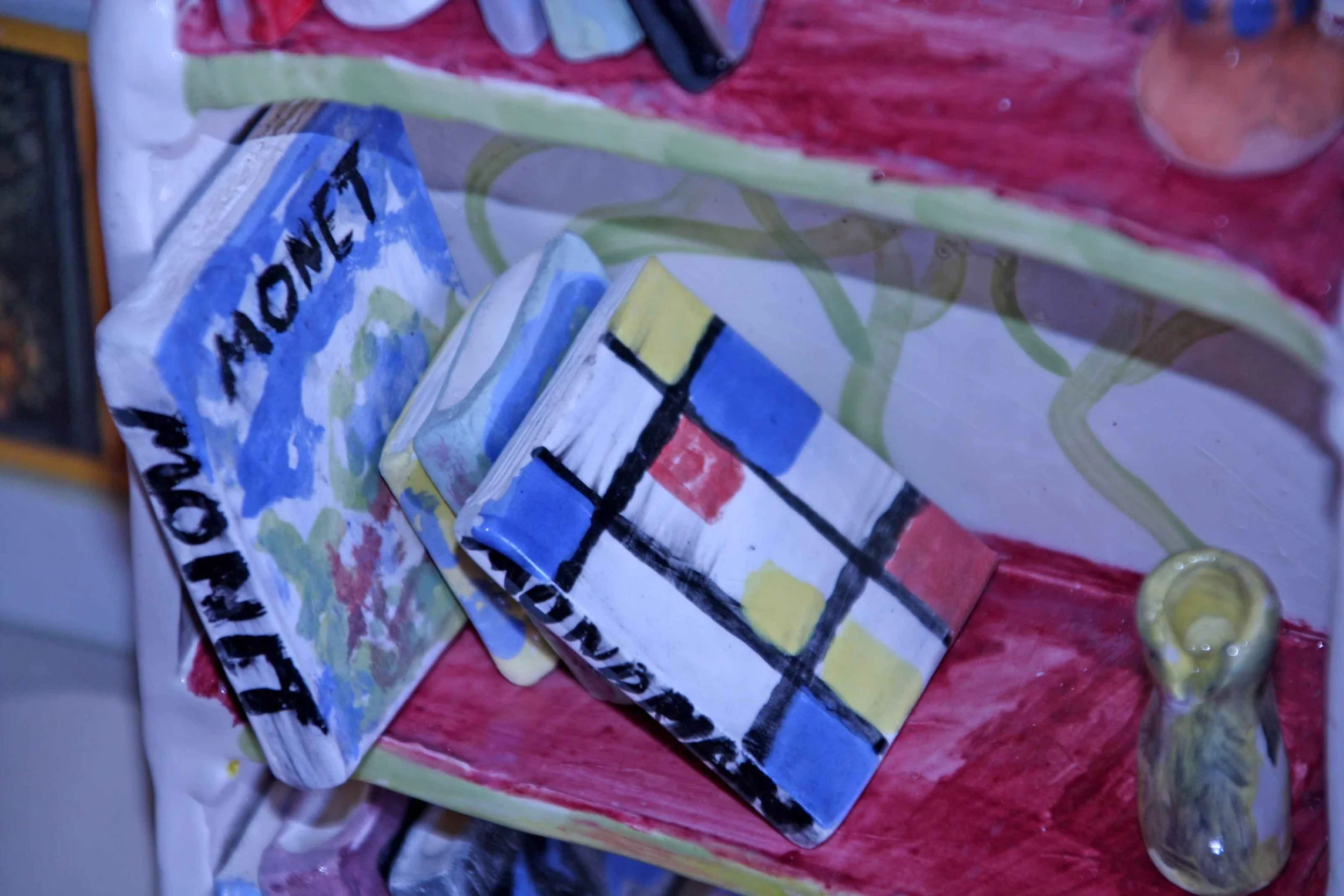 close up of ceramic books for dolls in a ceramic doll book shelf