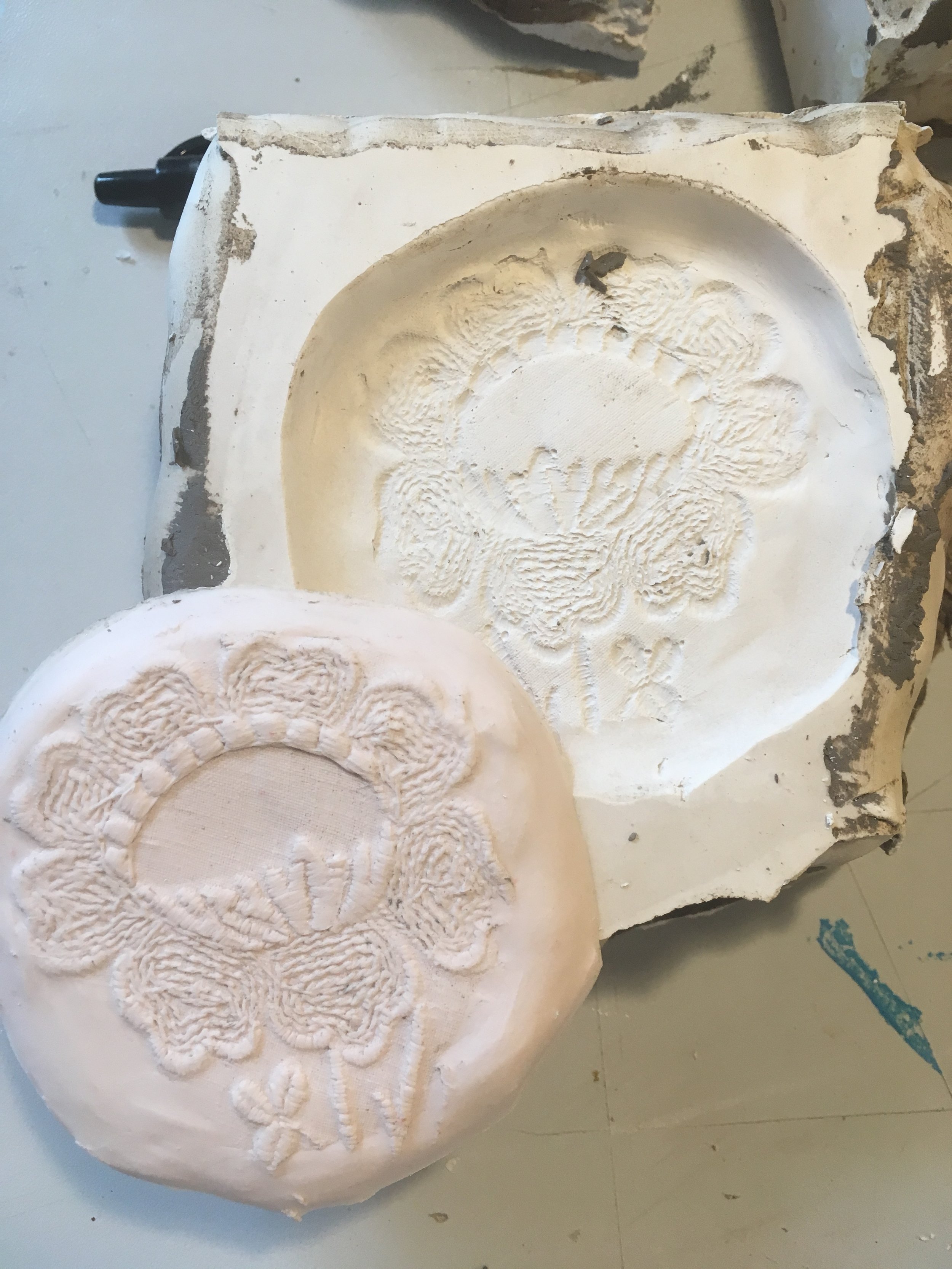 A plaster mold of a human skull with detailed carvings of the teeth, jaw, and surrounding bone structure.