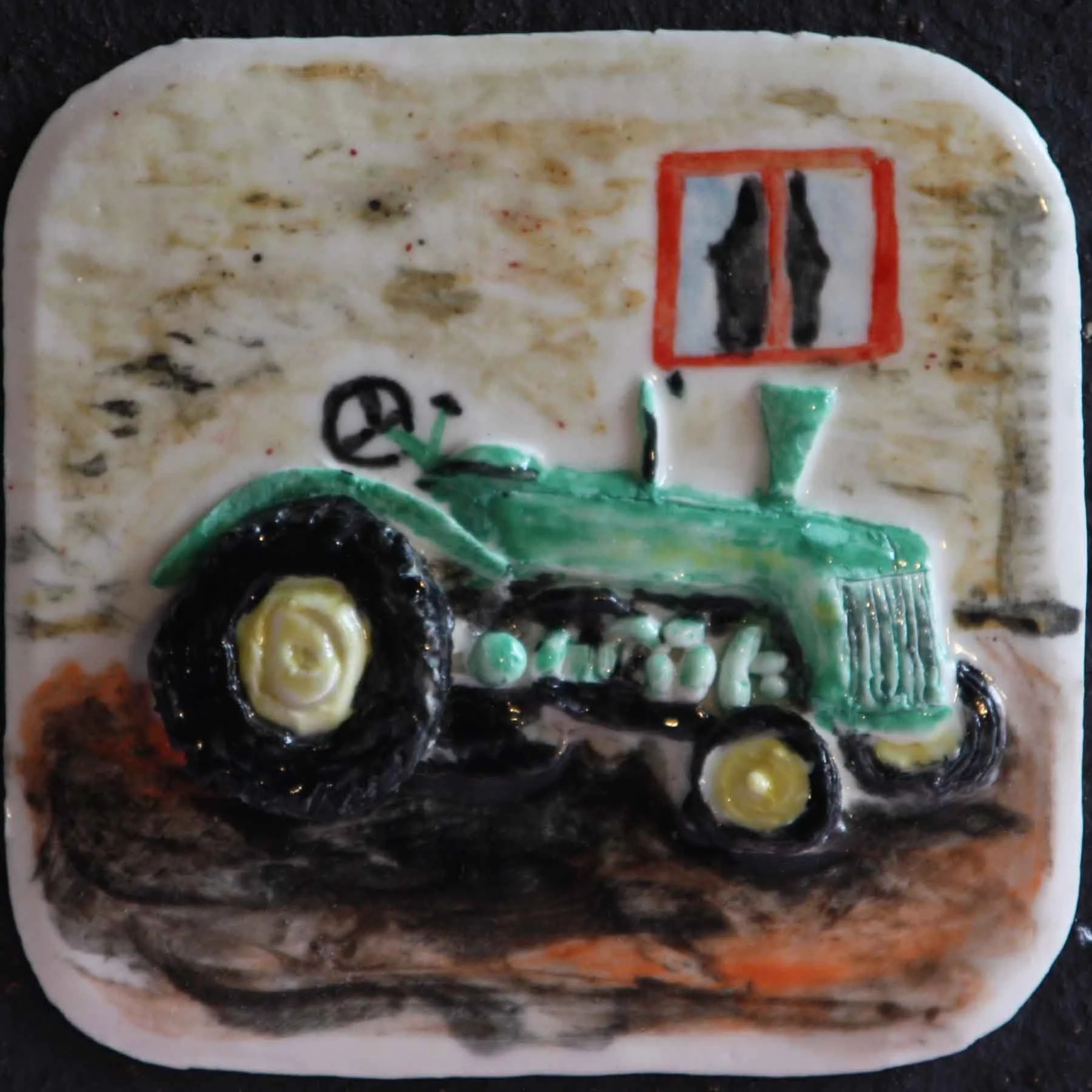 A ceramic decorative piece depicting a black and yellow flower, green leaves, and a green tractor, all in vibrant colors.