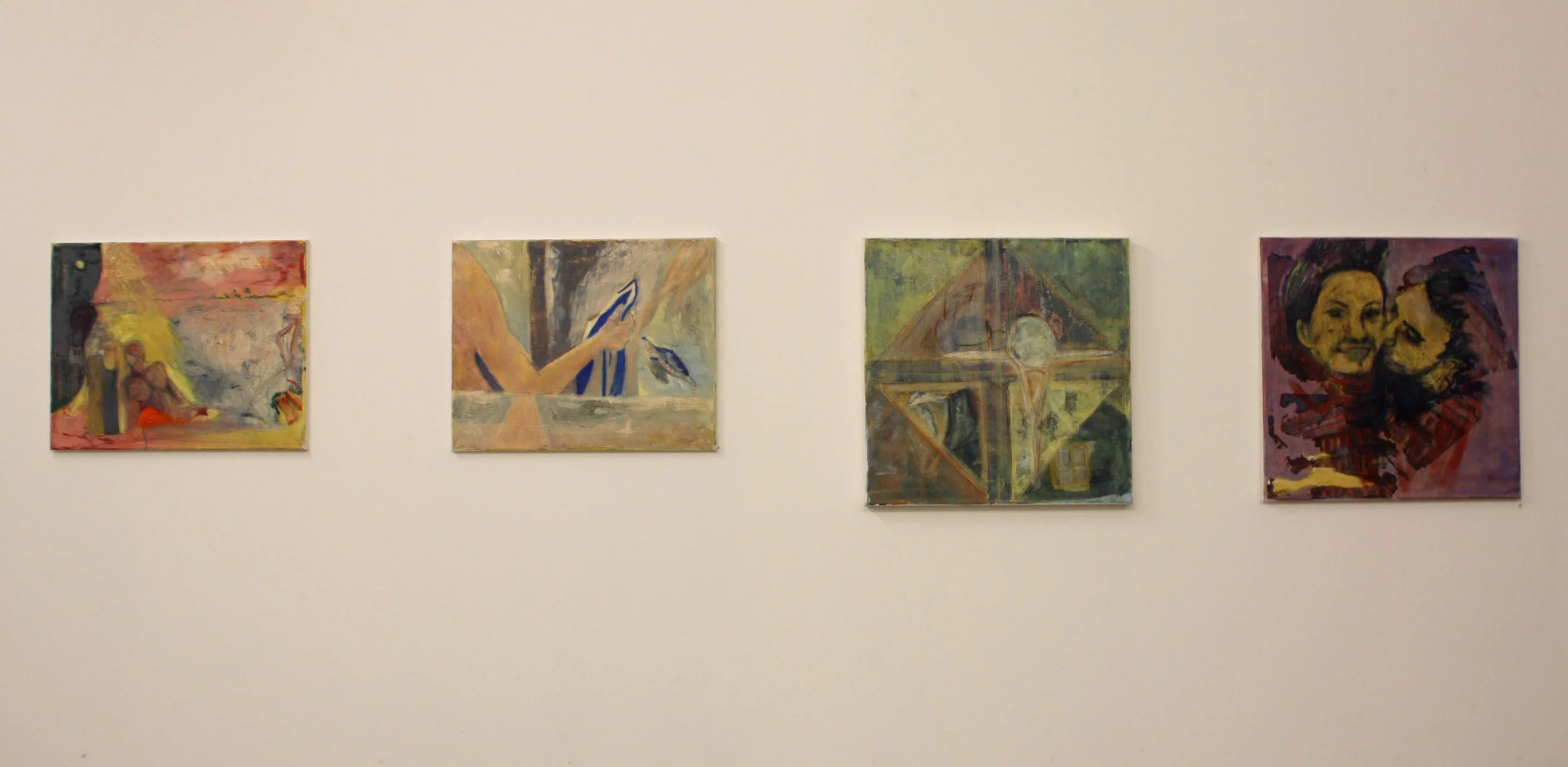Four abstract paintings hung on a white gallery wall, each featuring different colors and shapes.