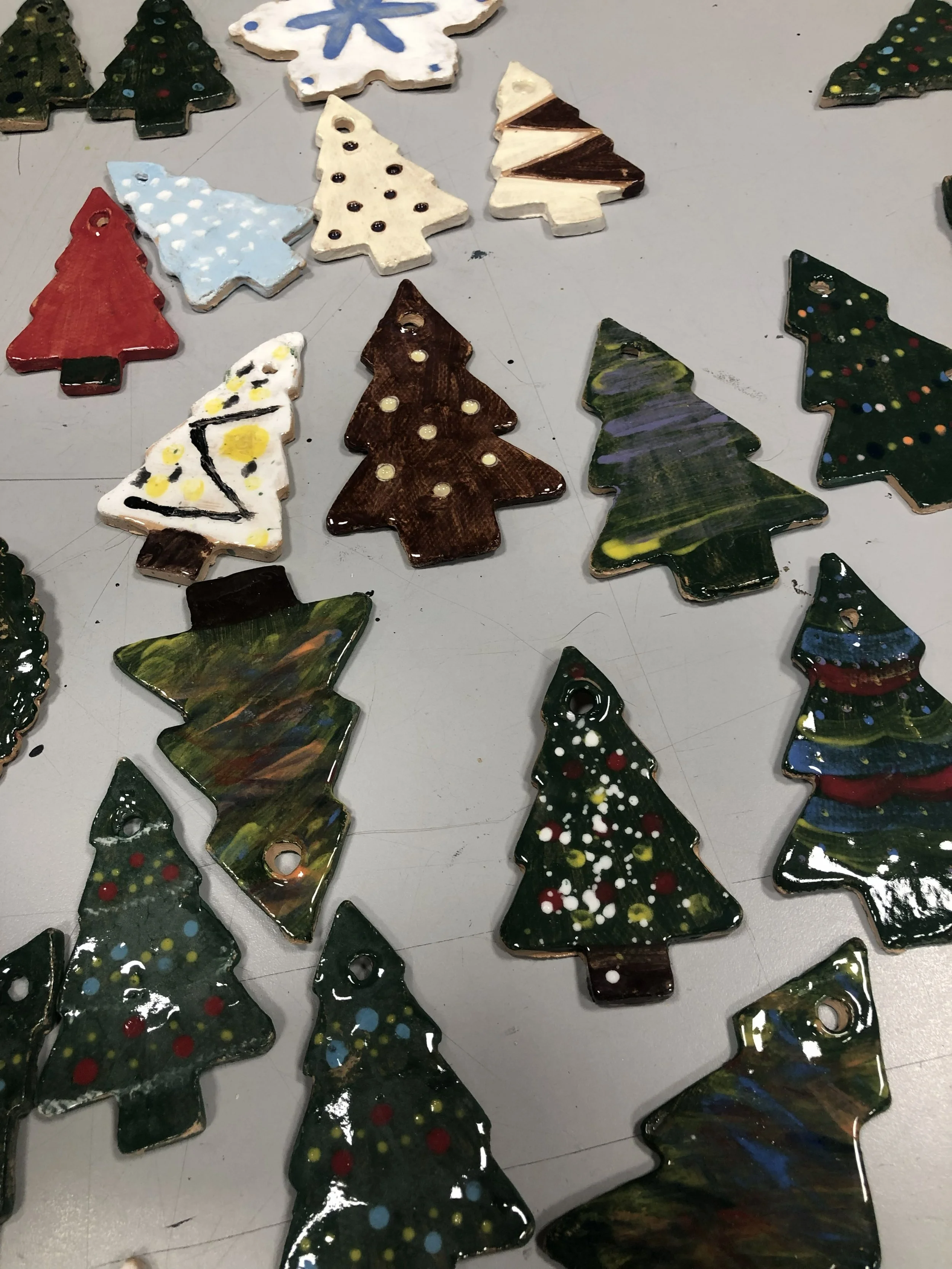 selection of flat christmas tree shaped tree decorations in different colours and patterns