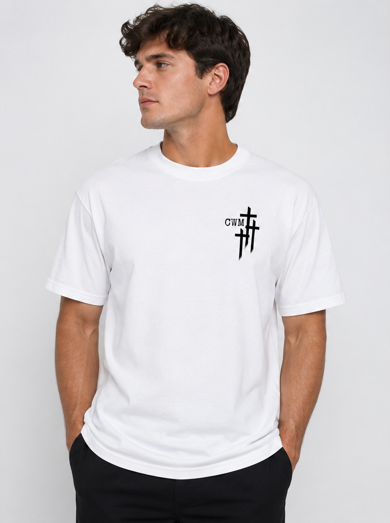 Young man wearing a white t-shirt with black printed crosses and the letters 'CWM' on the left chest, standing against a plain light gray background.