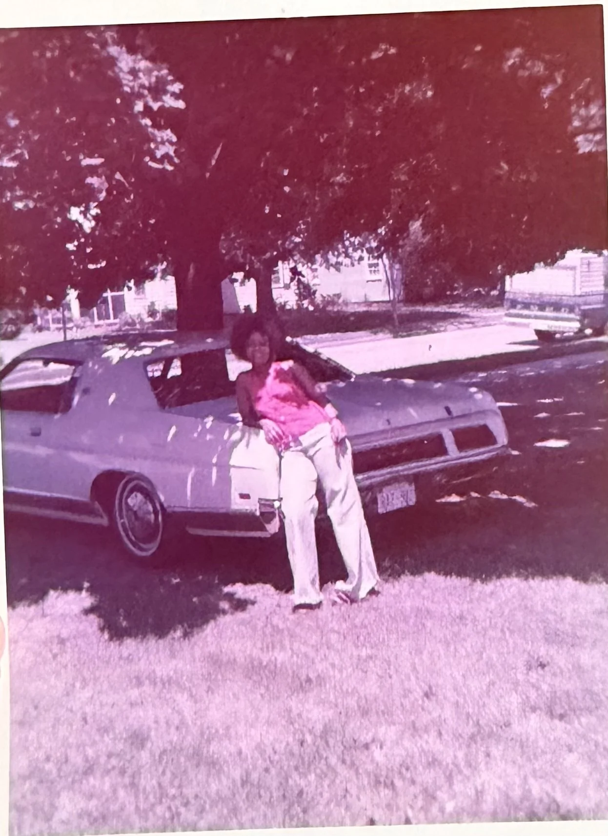 Glenda Fox in front of her yellow car
