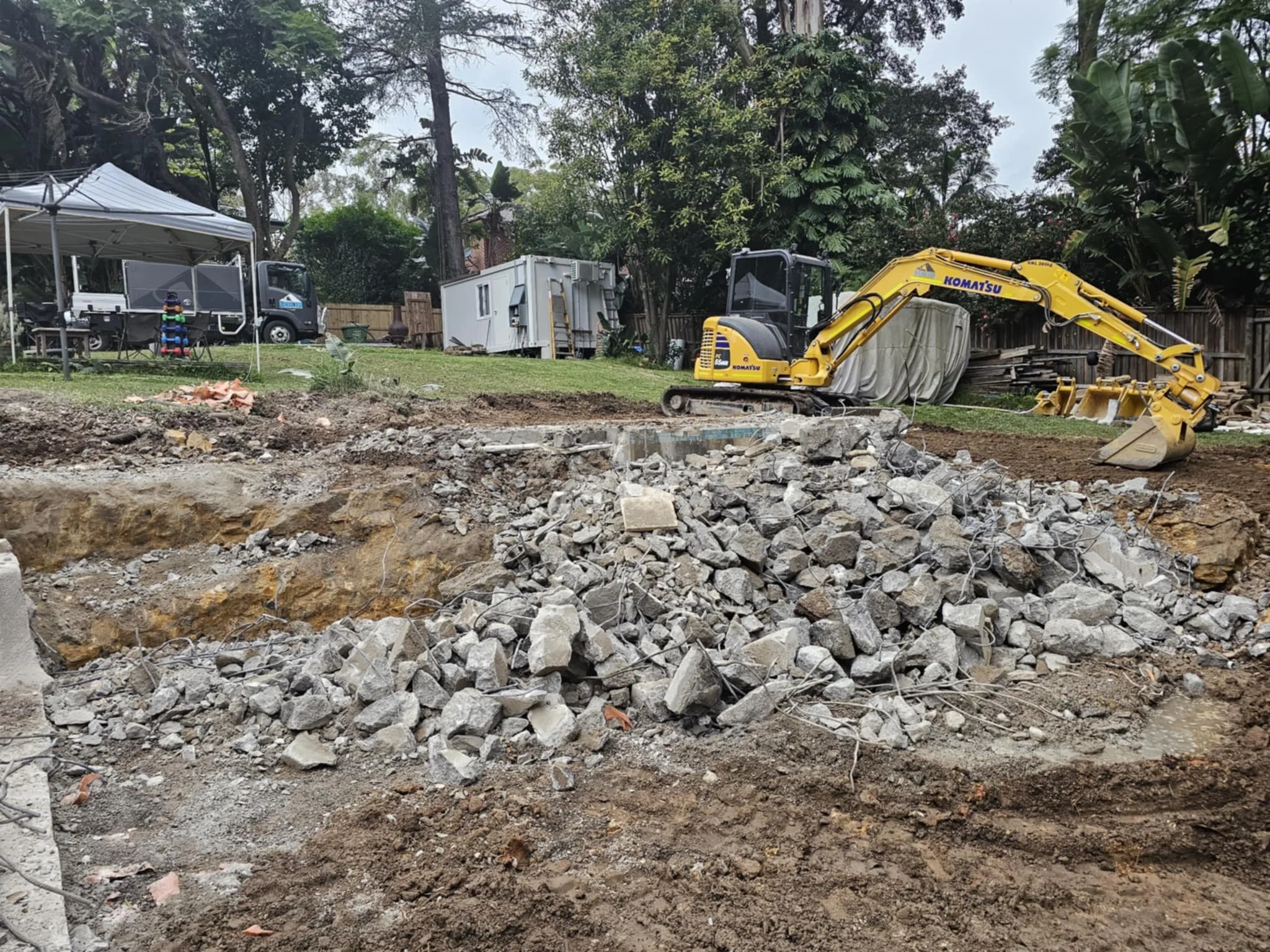 Excavator breaking rock and removing concrete in Wahroonga.