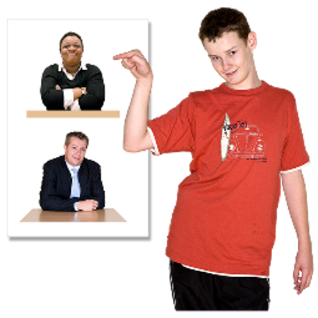 A young boy in a red t-shirt standing in front of two smaller images of adults, pointing to the adults with his finger.
