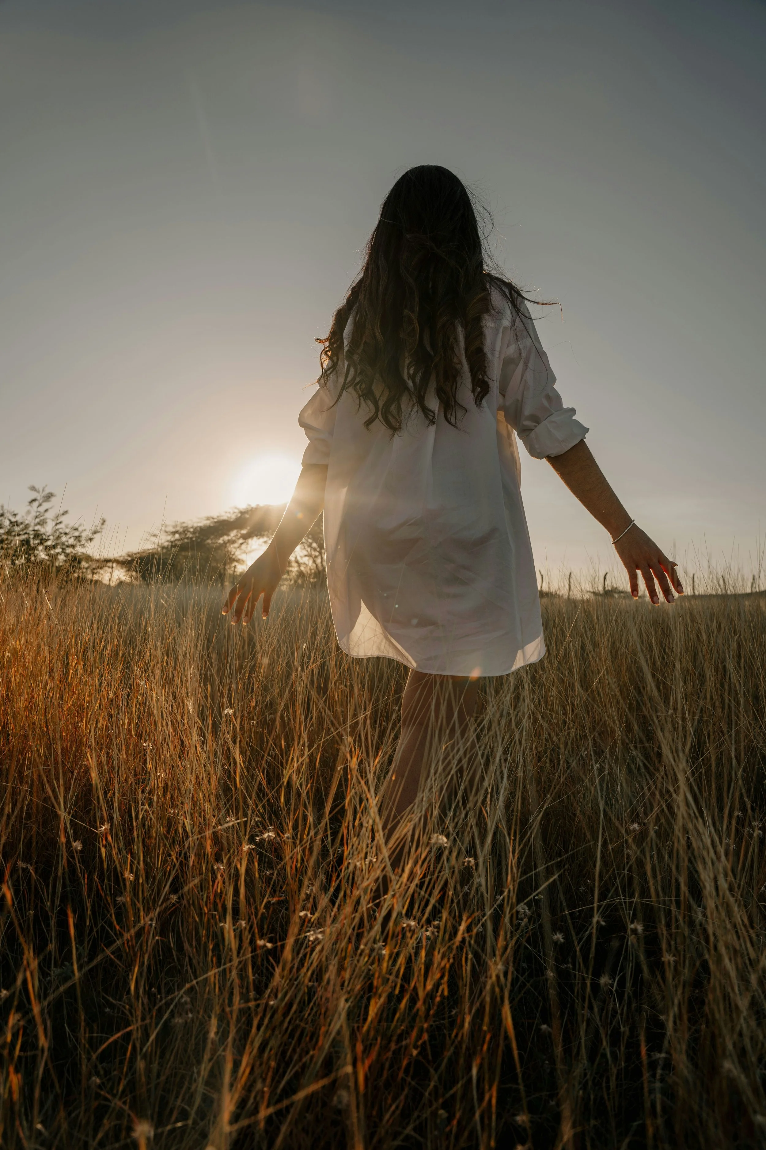 woman walking through a field
