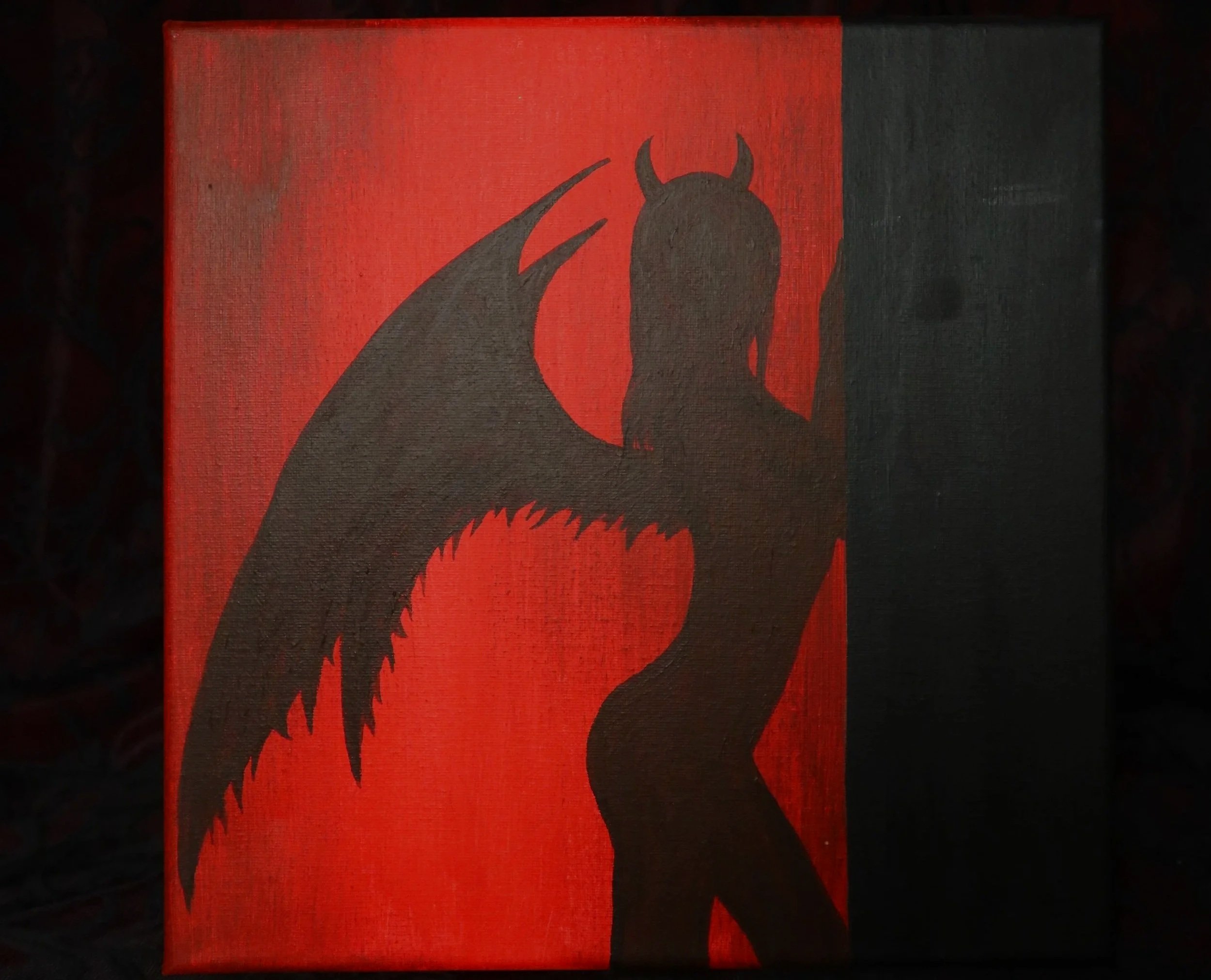 A painting of a silhouette of a woman with long hair, with a red background and black silhouette, featuring devil horns and a tail.