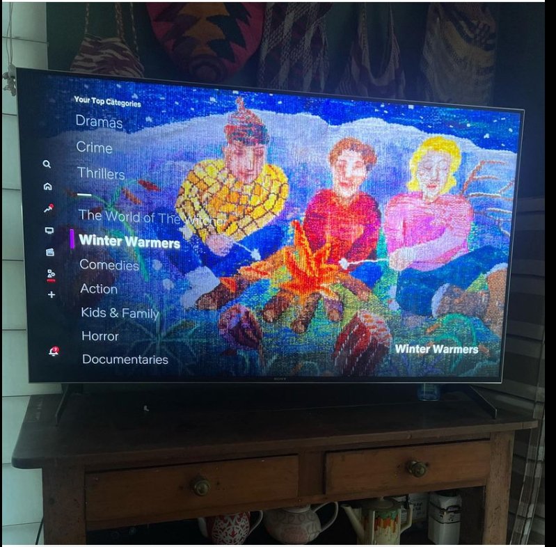 A television screen displays a menu for a streaming service with a colorful pixelated image of three animated characters, two women and one man, sitting in a winter landscape. The menu includes categories like Dramas, Crime, Thrillers, and Winter Warmers, with Winter Warmers highlighted.