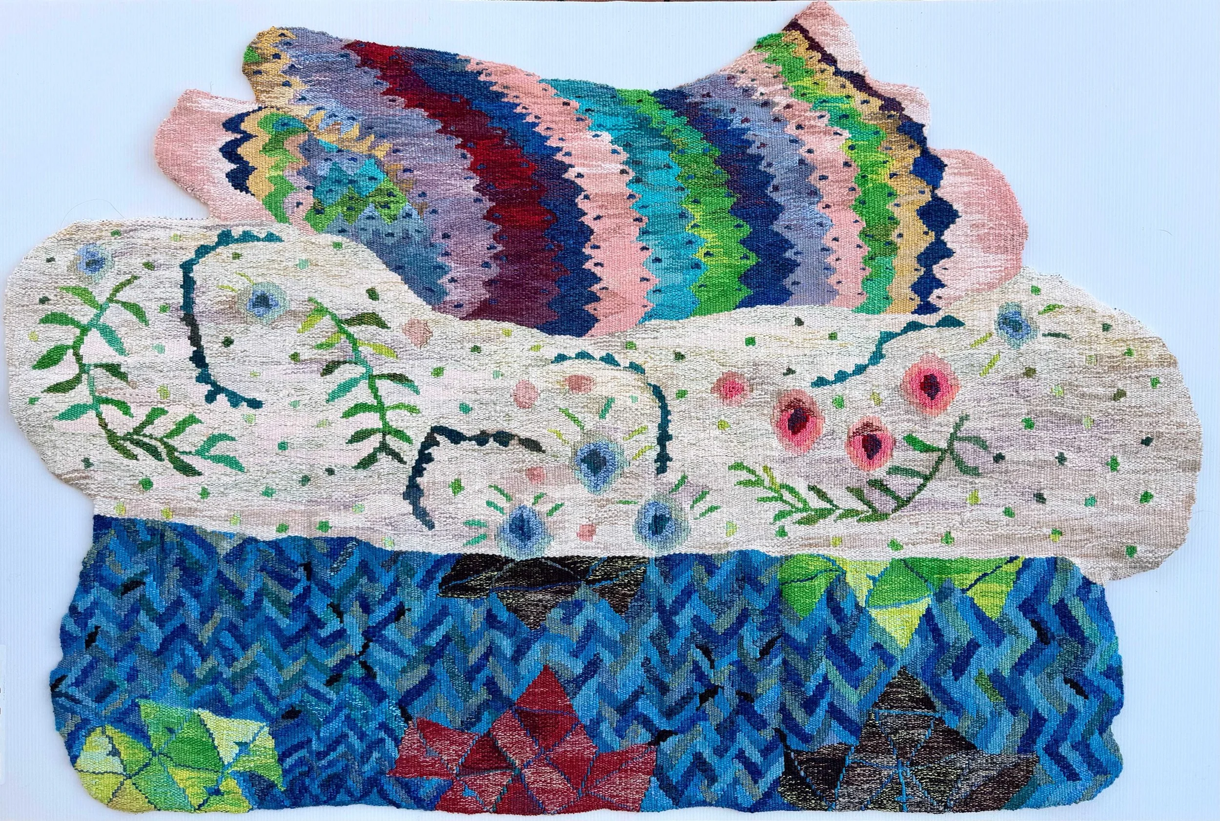 Three embroidered textile pieces with floral and geometric patterns in various colors, arranged overlapping on a flat surface.
