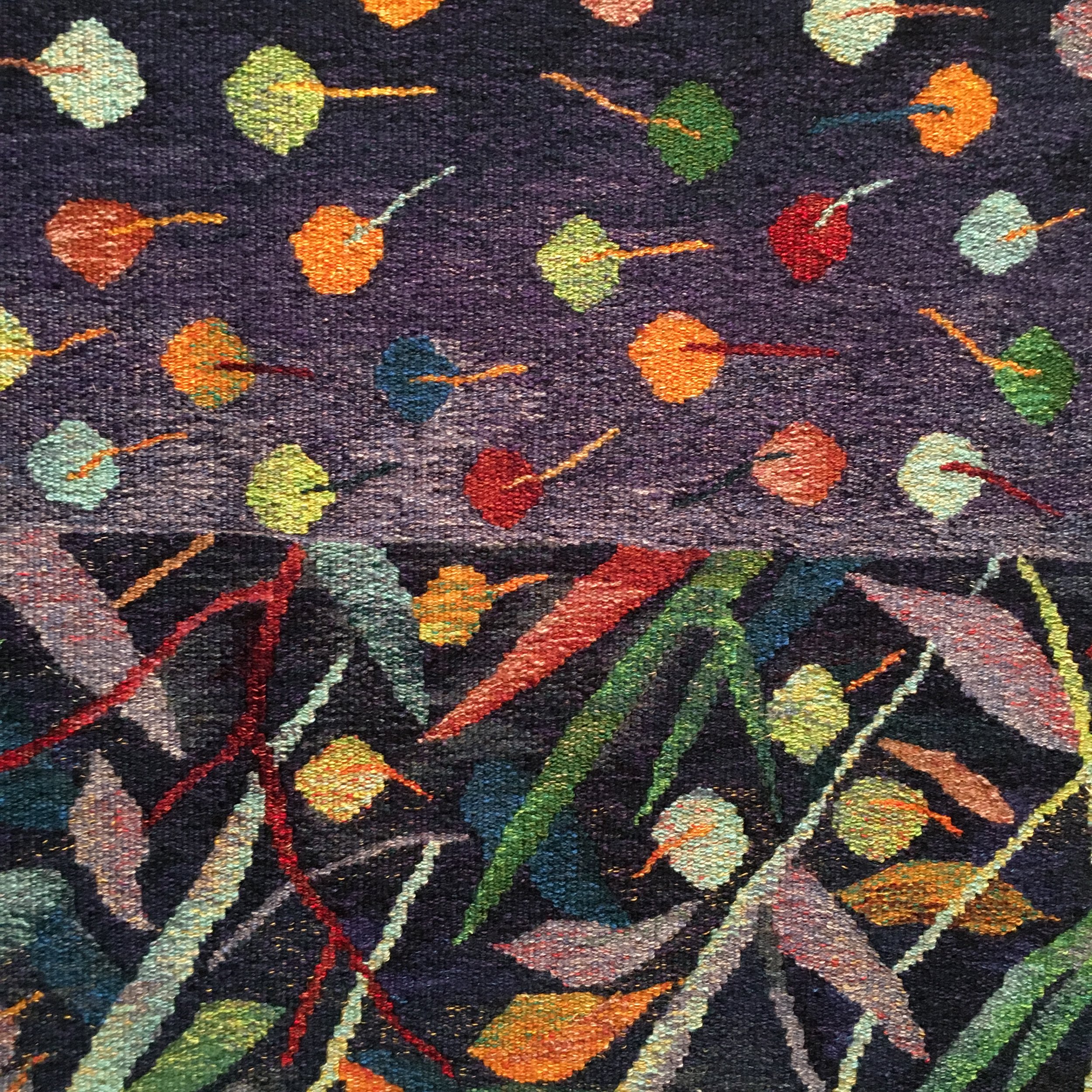 Woven Tapestry with a floral pattern on a dark background.