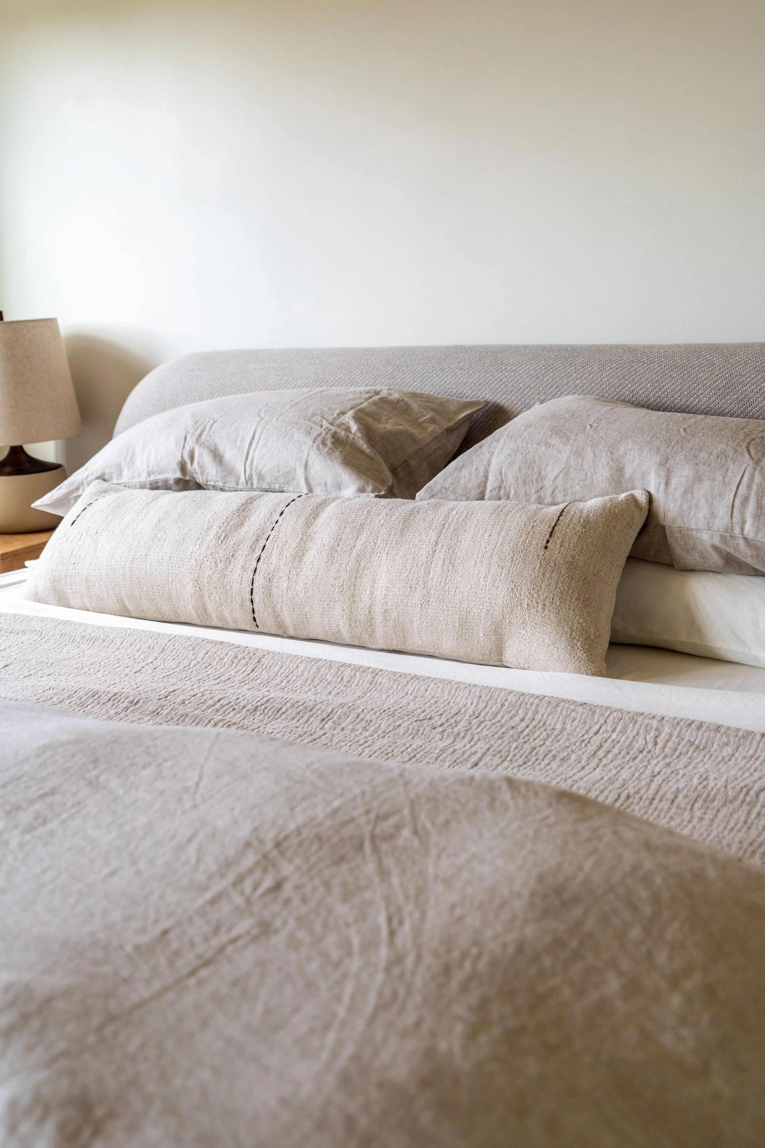 Luxury king bed with soft neutral linens at The Solana House in Solana Beach California