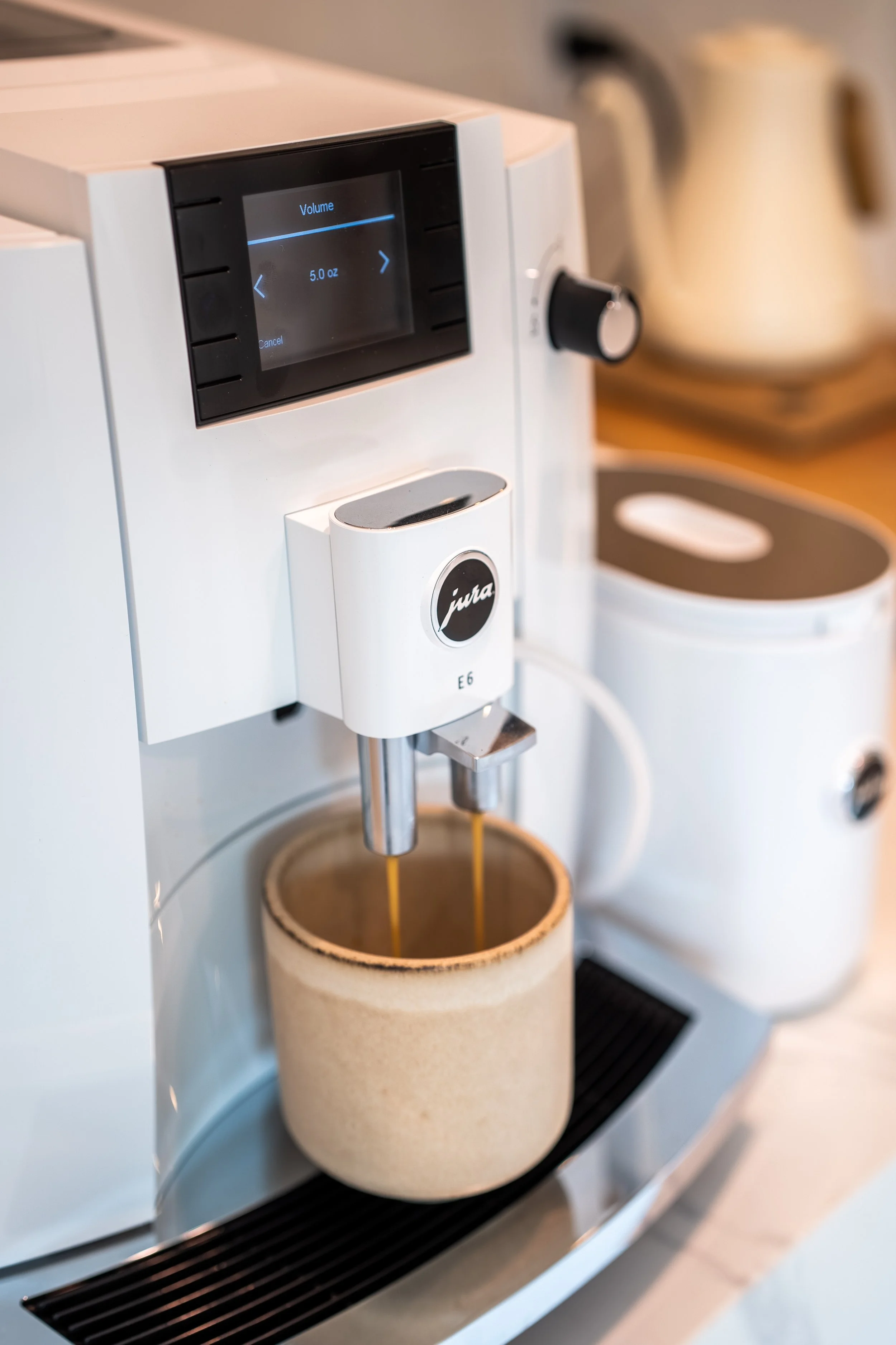 Jura espresso machine pouring fresh coffee in the fully equipped kitchen at The Solana House