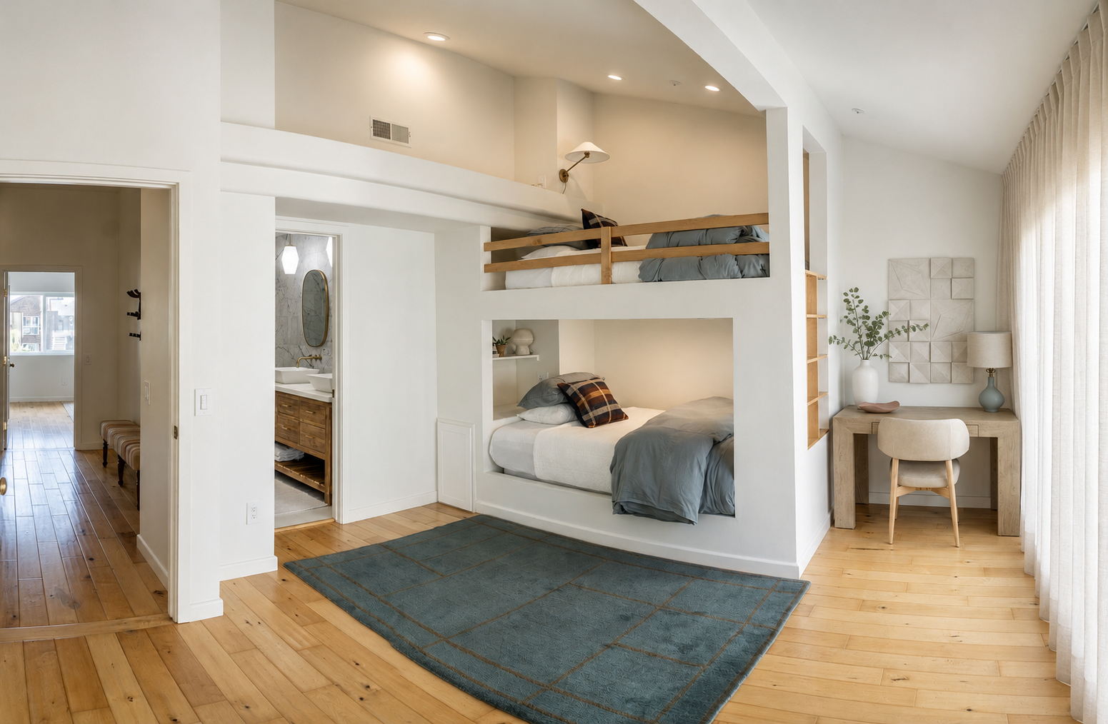 Bright bunk room at The Solana House with two full-size built-in beds, wood floors, storage and a dedicated desk area.