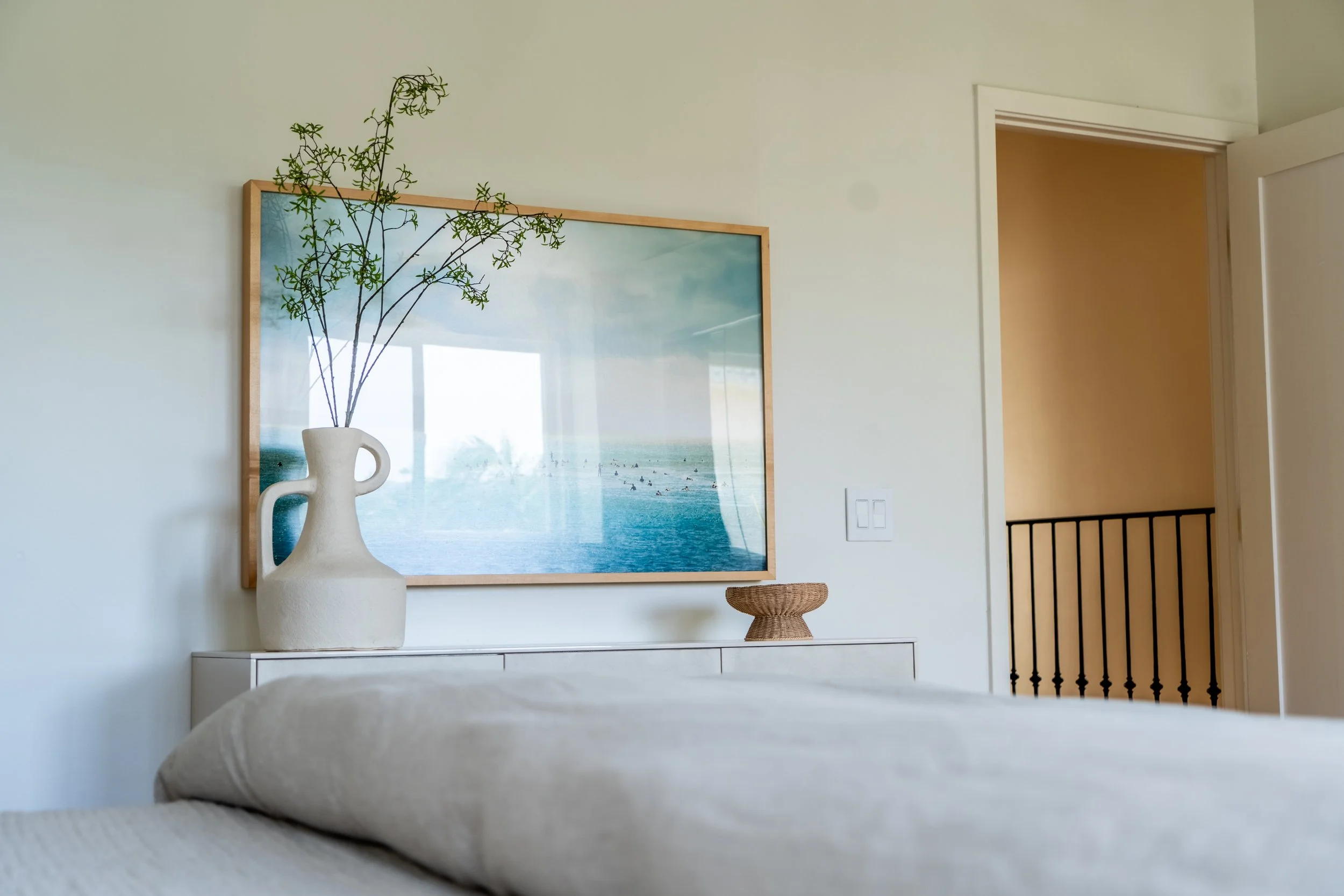 Serene primary bedroom at The Solana House with neutral coastal styling, soft linens, and thoughtfully curated details.