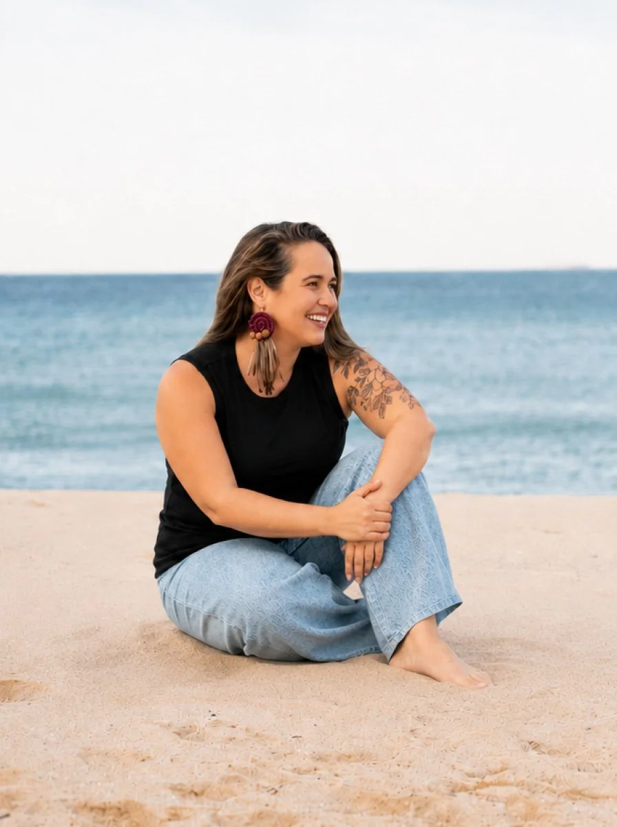 emdr therapist woman sitting on beach, smiling