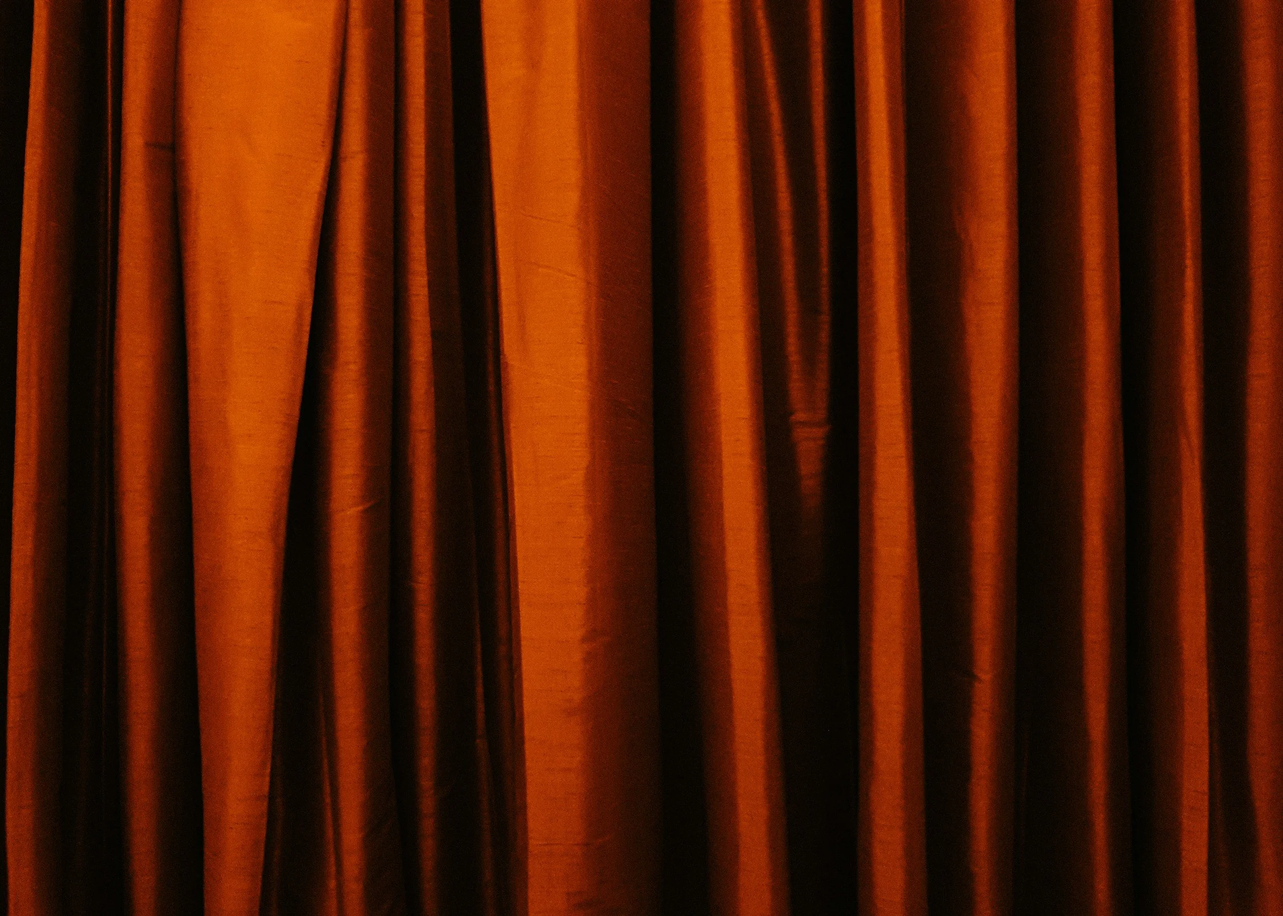 Orange theater curtains closed.