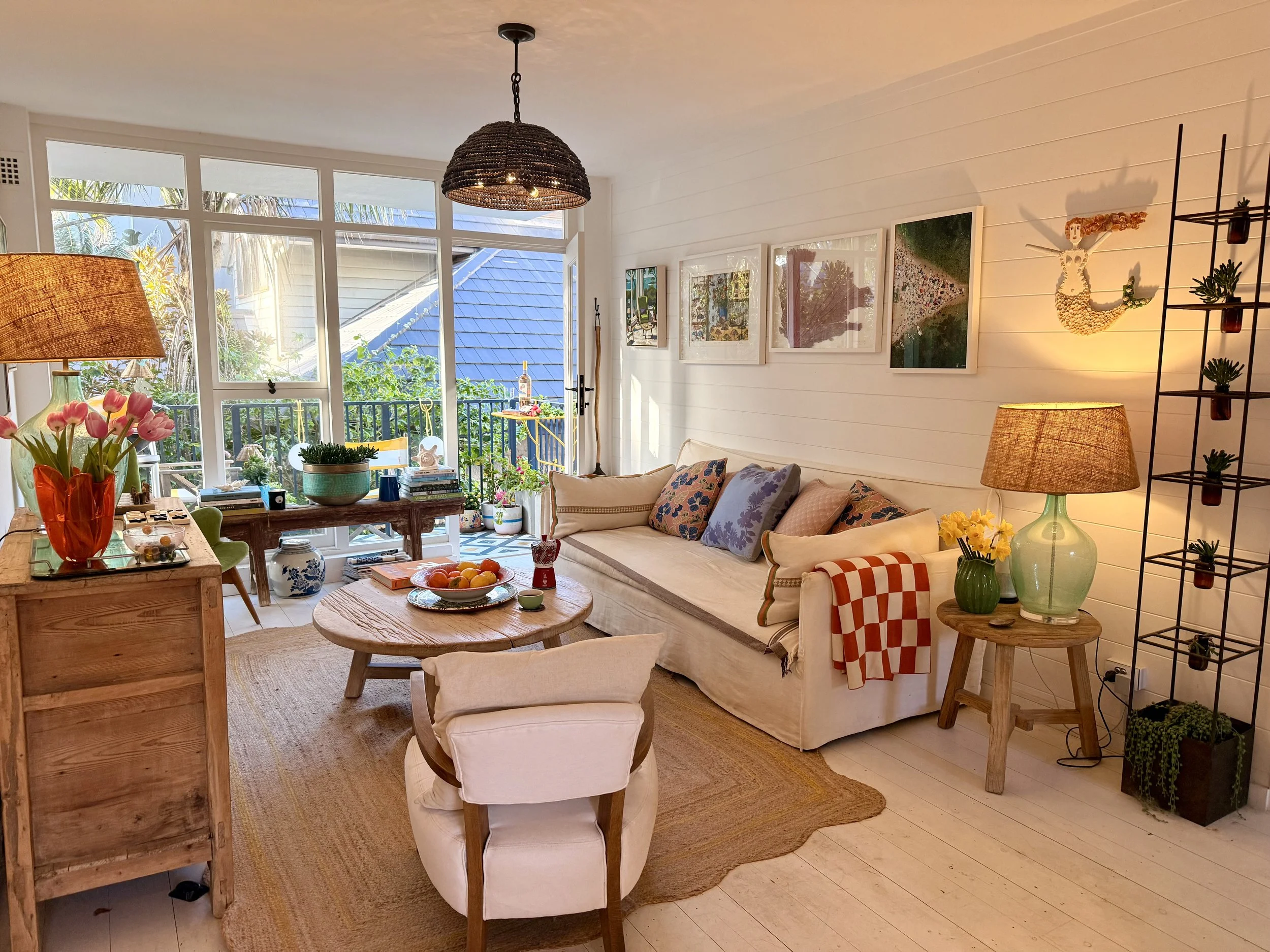 Colourful Sea Fan living room opening onto the balcony, with ocean view and tropical garden views.