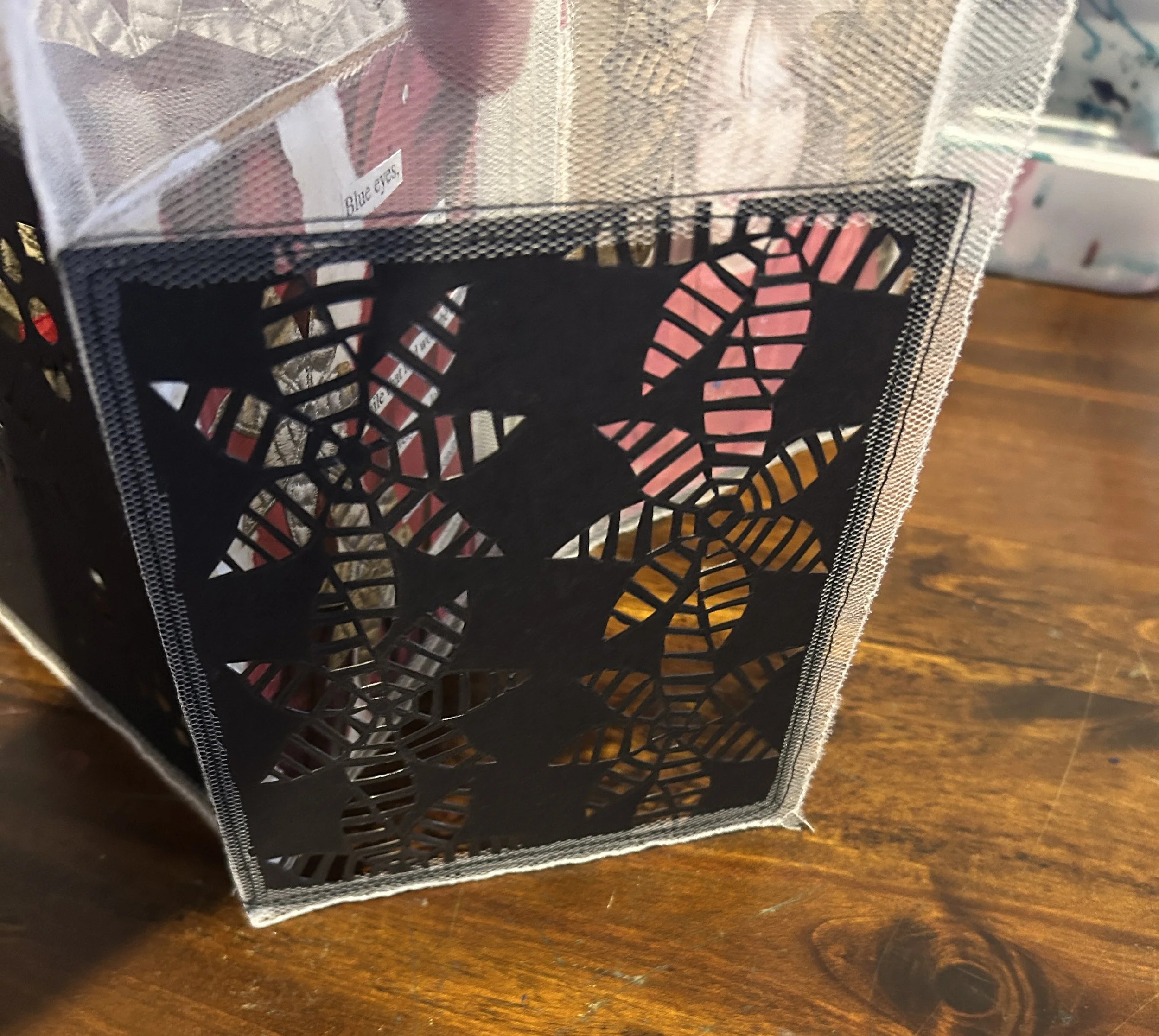 This art book uses netting/heavy tulle to 'hold' each of the pages.