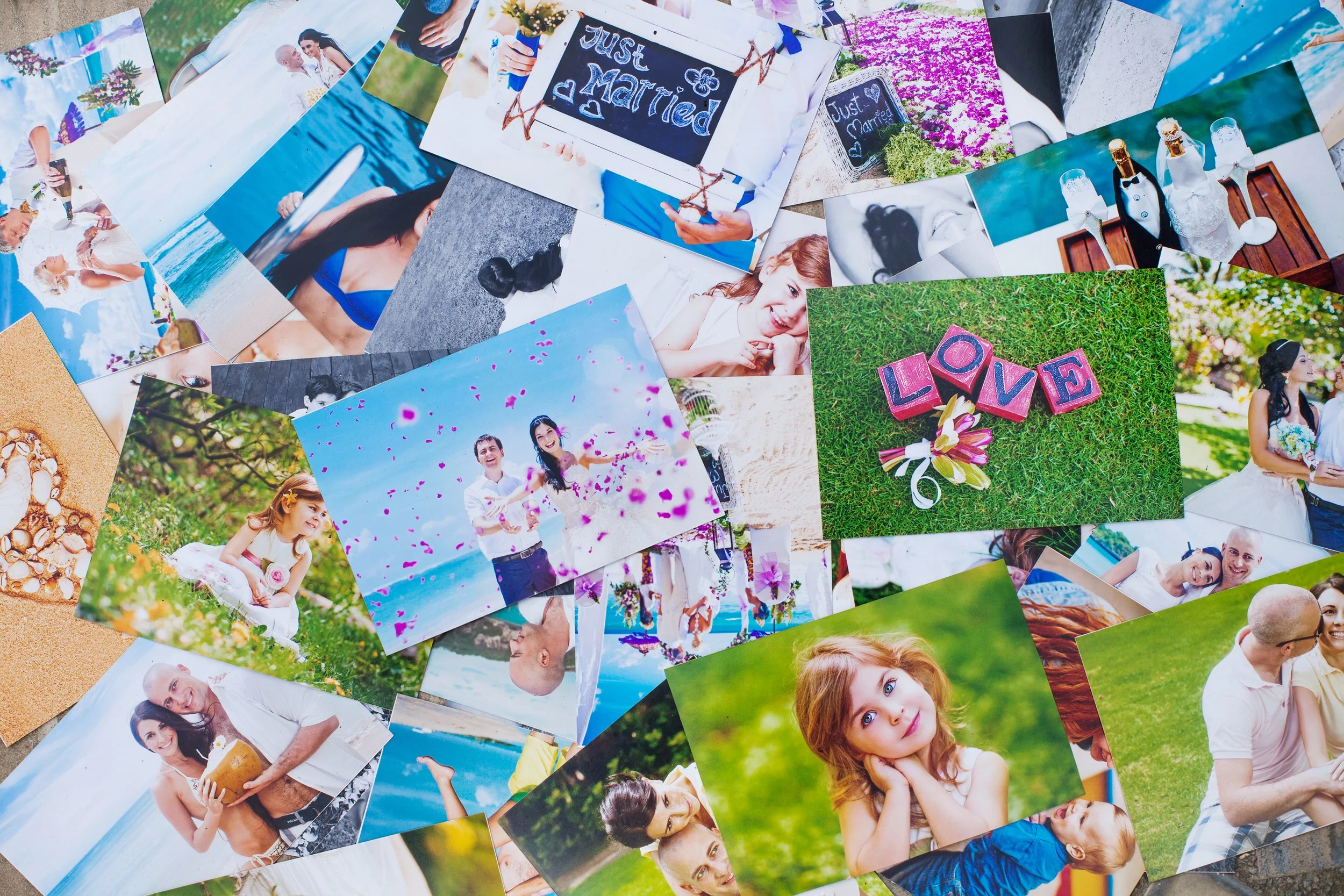 vecteezy_a-pile-of-photos-on-a-table-with-a-couple-in-the-middle_27612261.jpg