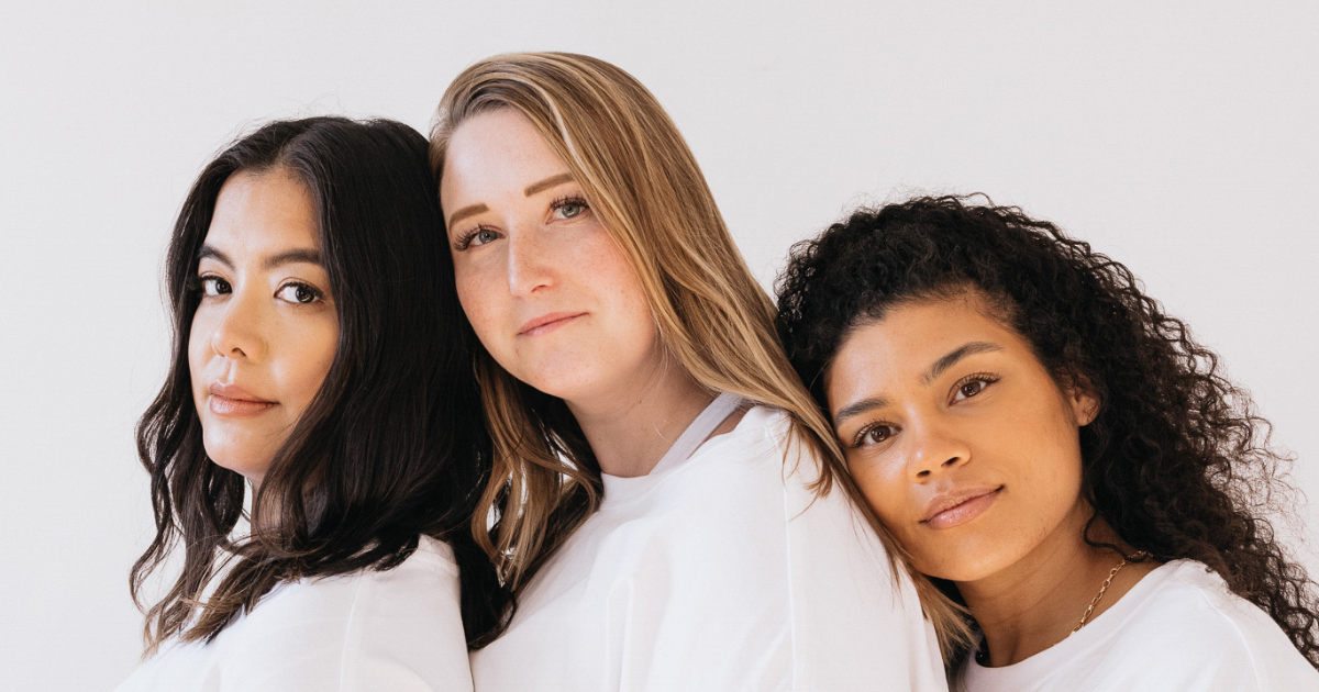 Three women leaning on each other in peaceful closeness – representing trust, compassion, and the Caregiving Virtue of The Soul Award