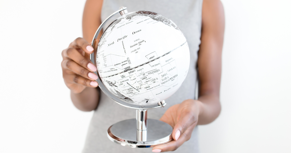 Close-up of a woman gently holding a sleek white globe – representing vision, possibility, and the Inspiration Virtue of The Soul Award