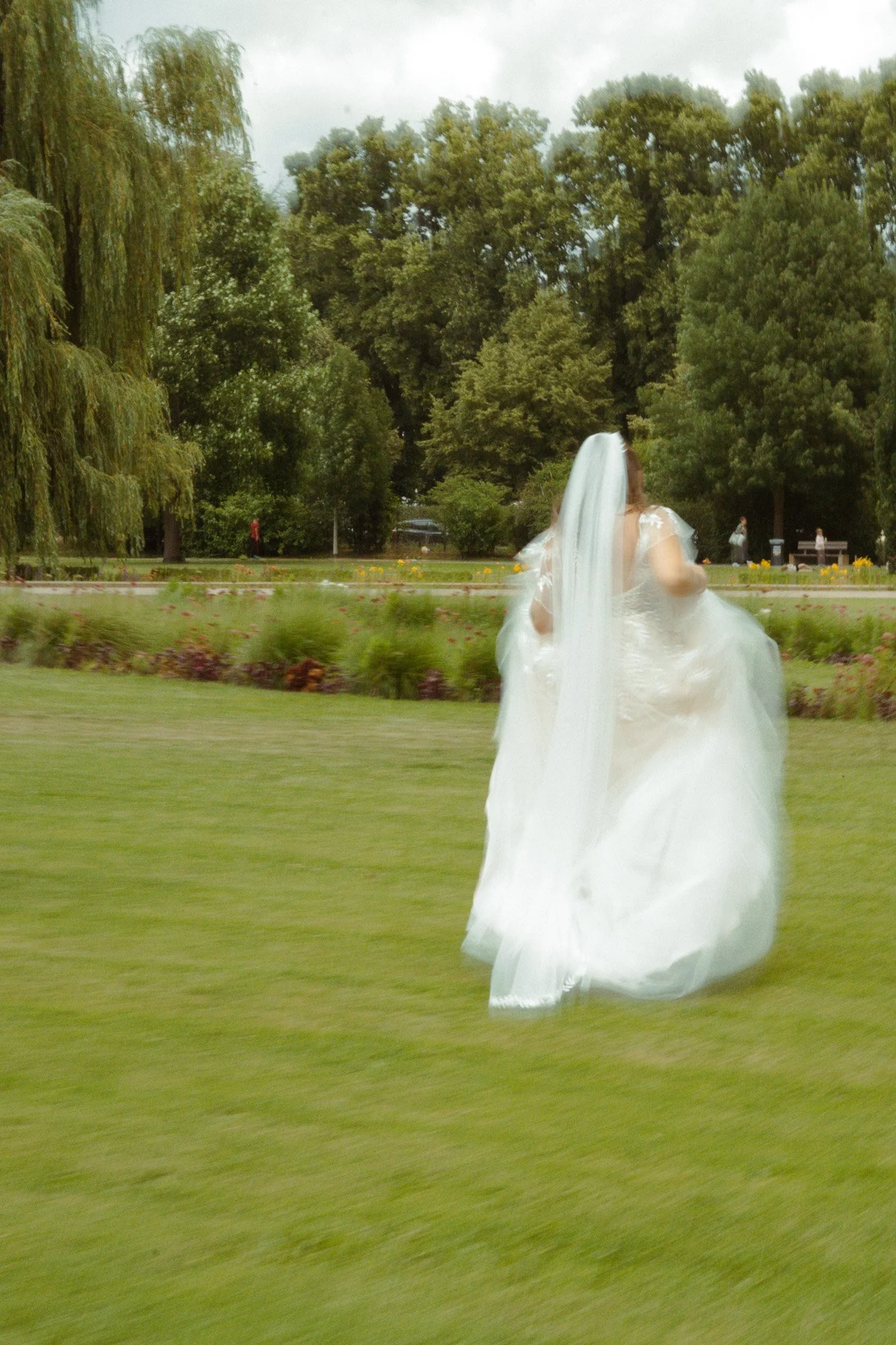 Braut im weißen Kleid auf einer grünen Wiese