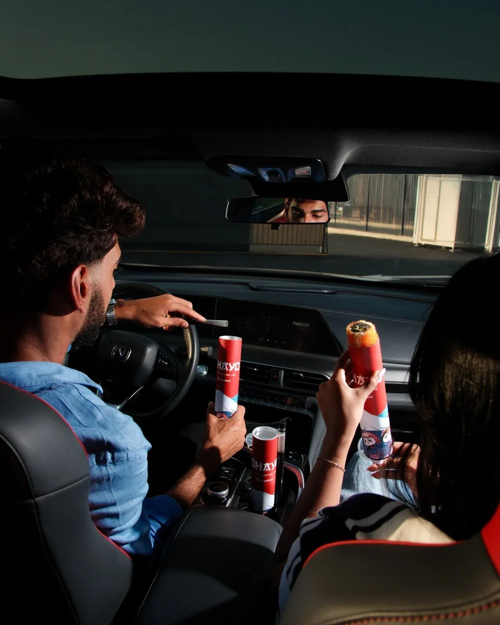 Driver and passenger sharing Ohayo in a car