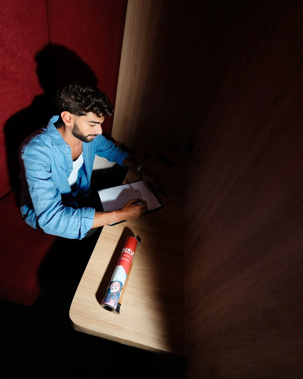 Man in a red booth with an Ohayo on the table