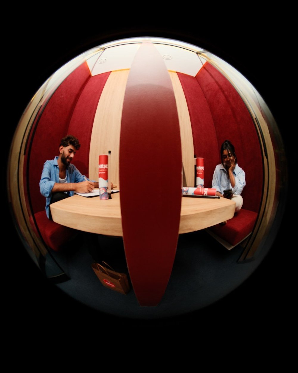 Fisheye view of a red booth with Ohayo on the table