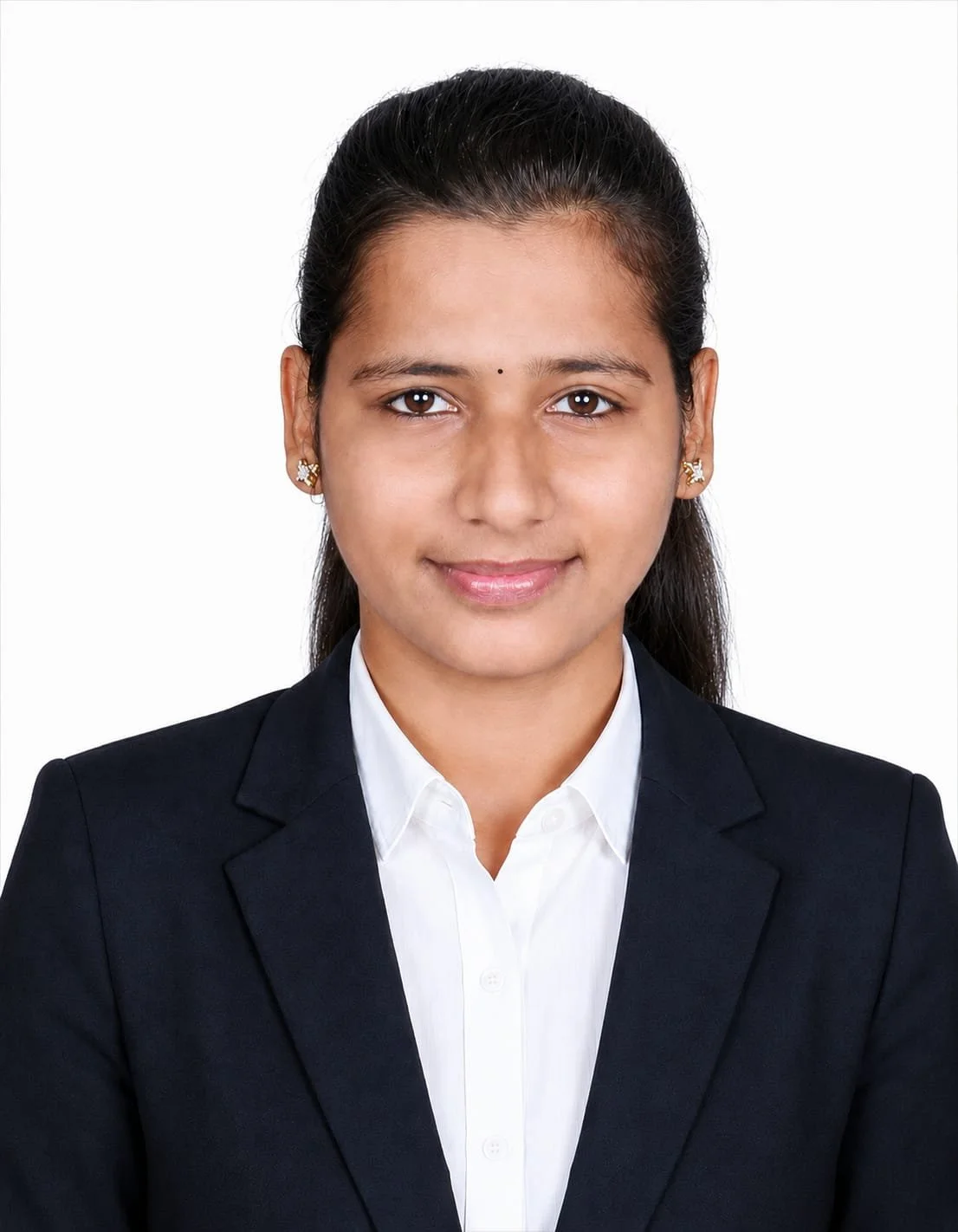 A professional headshot of a young woman with long dark hair, wearing a black blazer and white shirt, smiling against a white background.