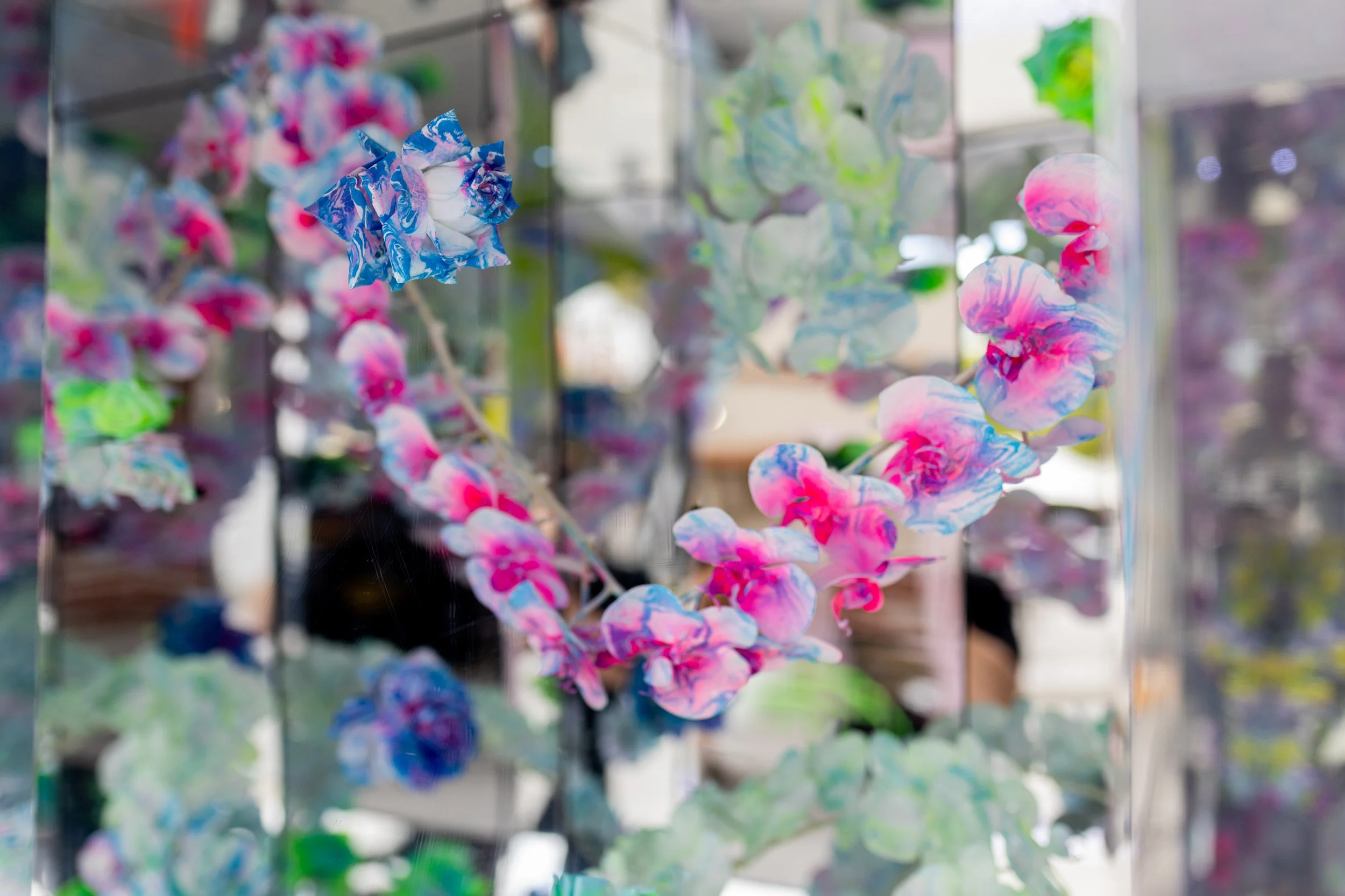 HR Productions Custom built artist collaboration. ACID FLWRS Perth outdoor installation. neon colours. Colourful dipped floral garlands on a mirrored chrome stand in an outdoor setting