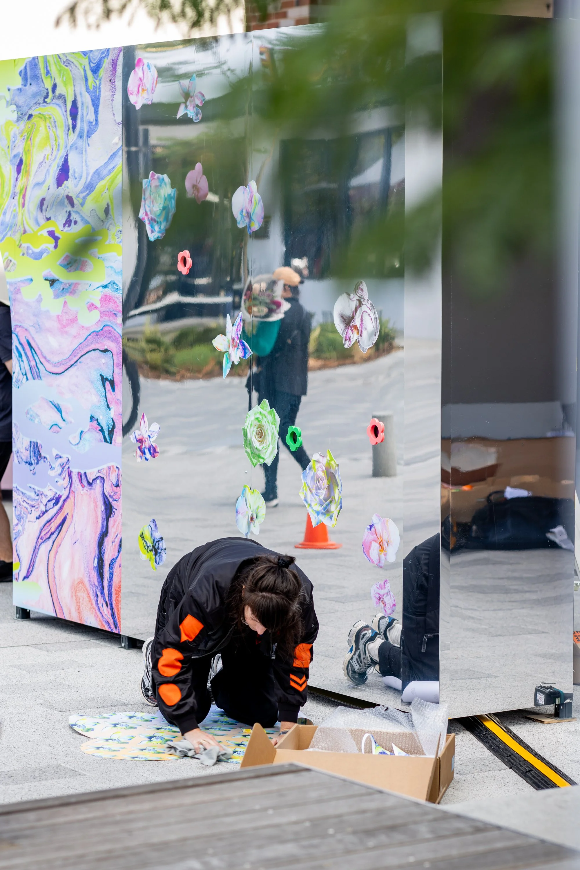 HR Productions Custom built artist collaboration installation. ACID FLWRS Perth outdoor installation. neon colours. Colourful dipped florals on green display stand in an outdoor setting, neon green large stand