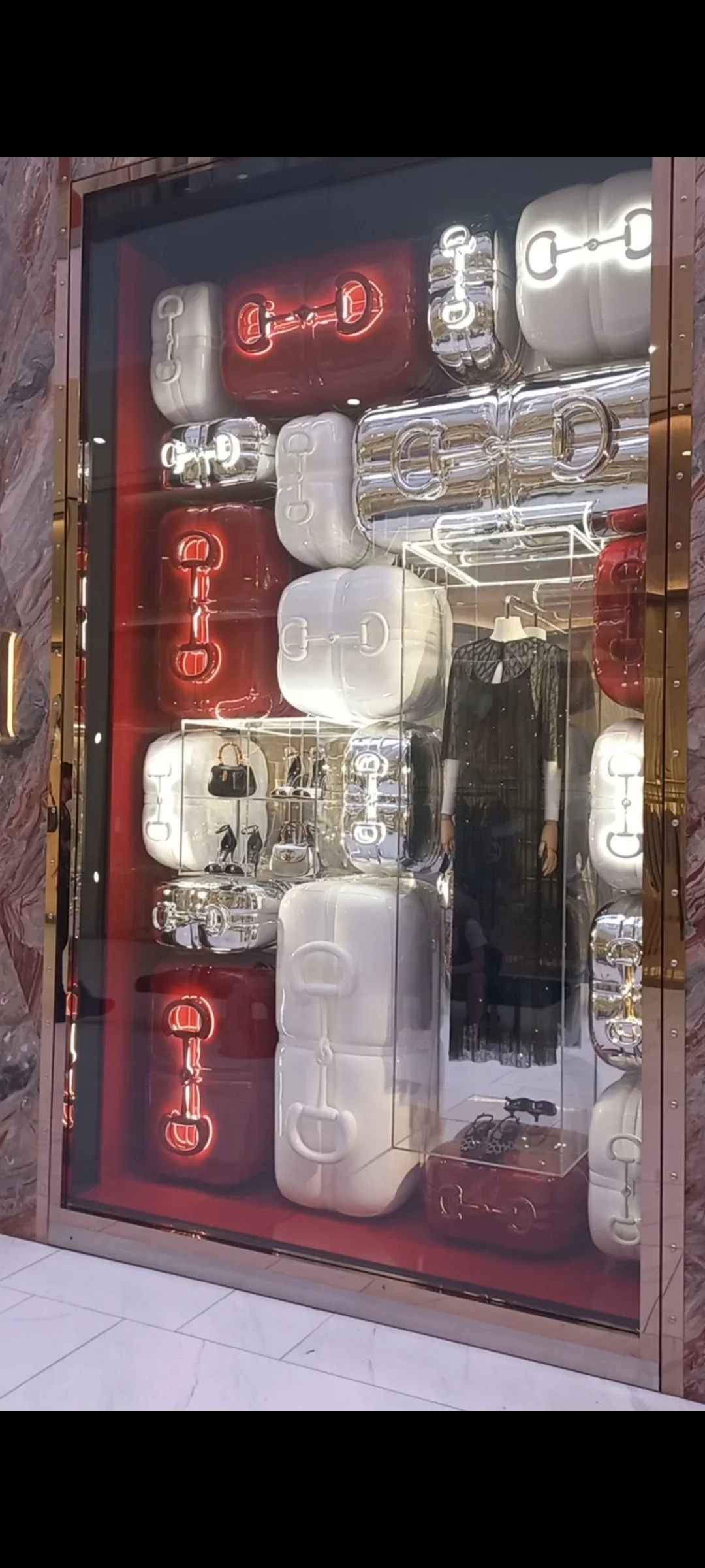 Display with handbags and shoes high gloss burgundy red plinths, illuminatedLED props. HR Productions custom props & lighting, sydney HIGH END luxury retail window
