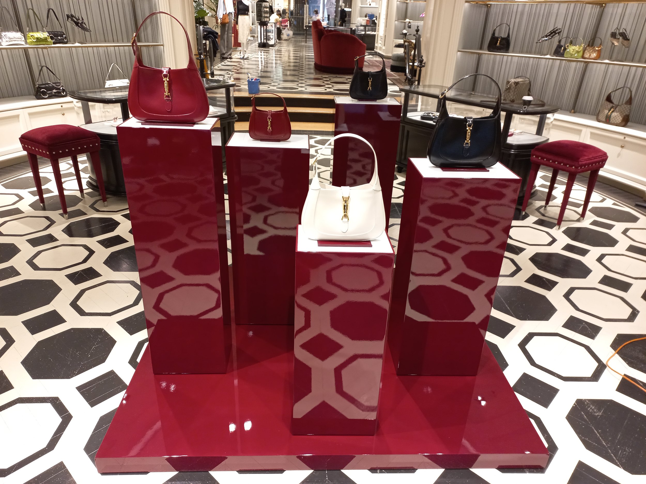HR Productions custom props, plinths, high gloss burgundy red with high gloss pedestal base. High end retail installation. Sydney, custom built. 