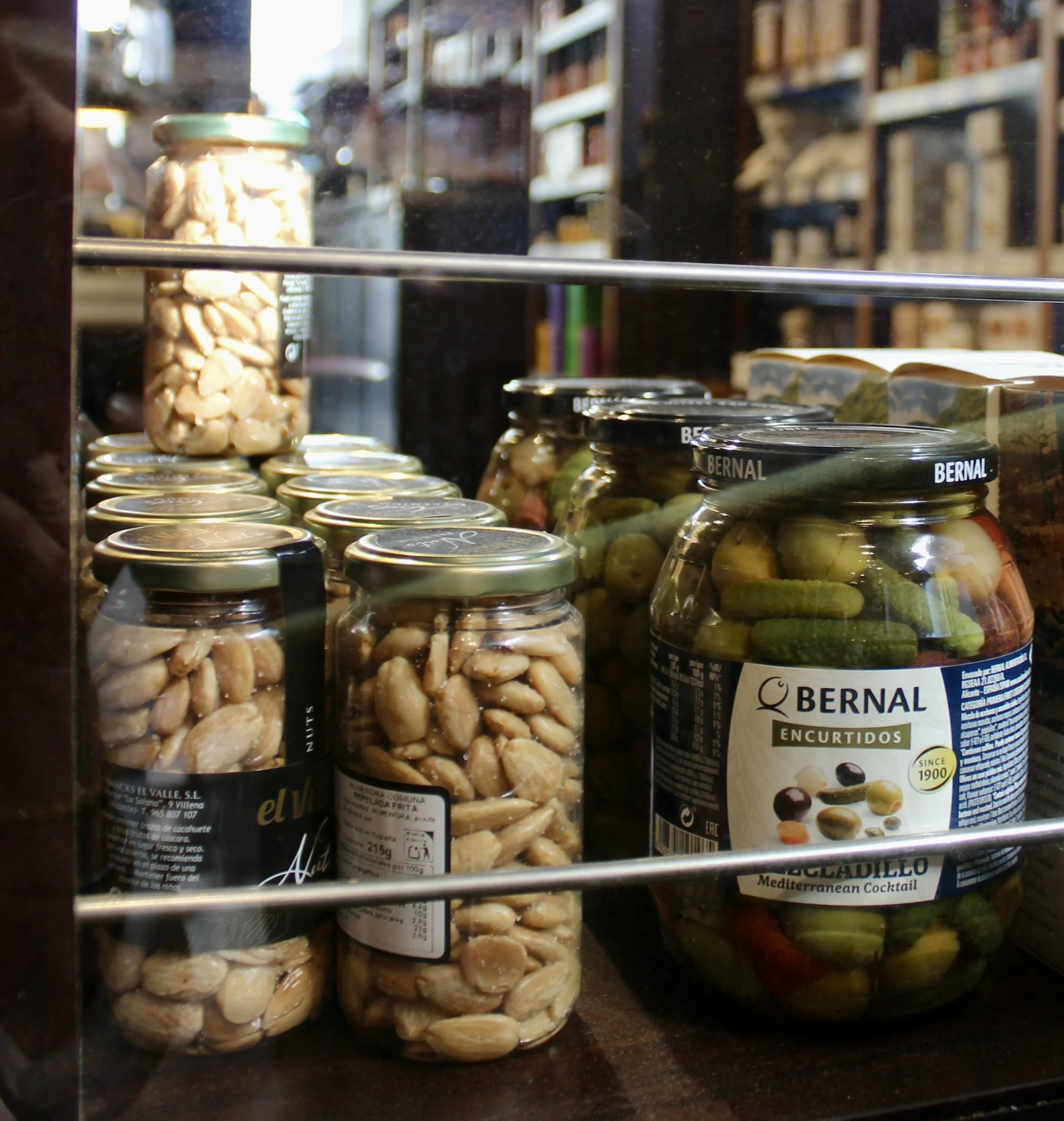 Close‑up of assorted jars of preserved vegetables and nuts on a shelf in a Liverpool restaurant