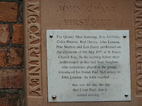 Commemorative plaque for The Quarry Men listing band members and their 1957 St Peter’s Church fete performance, mounted on a brick wall in Liverpool