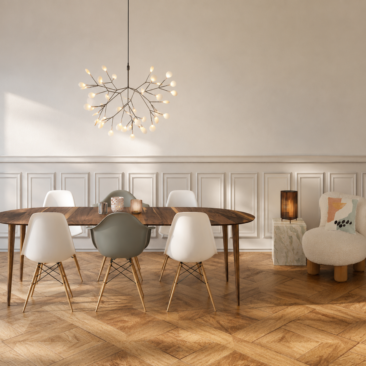 Modern dining room with wooden table, white and grey chairs, a pendant light, a small side table with a lamp, and a chair with a decorative pillow.