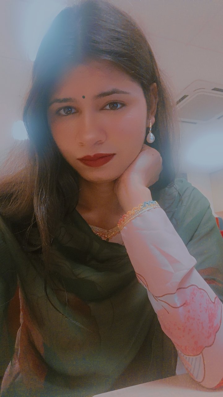 A portrait of Paakhi Bhatt in an indoor setting, looking thoughtful while resting her chin on her hand, representing guidance and emotional clarity.