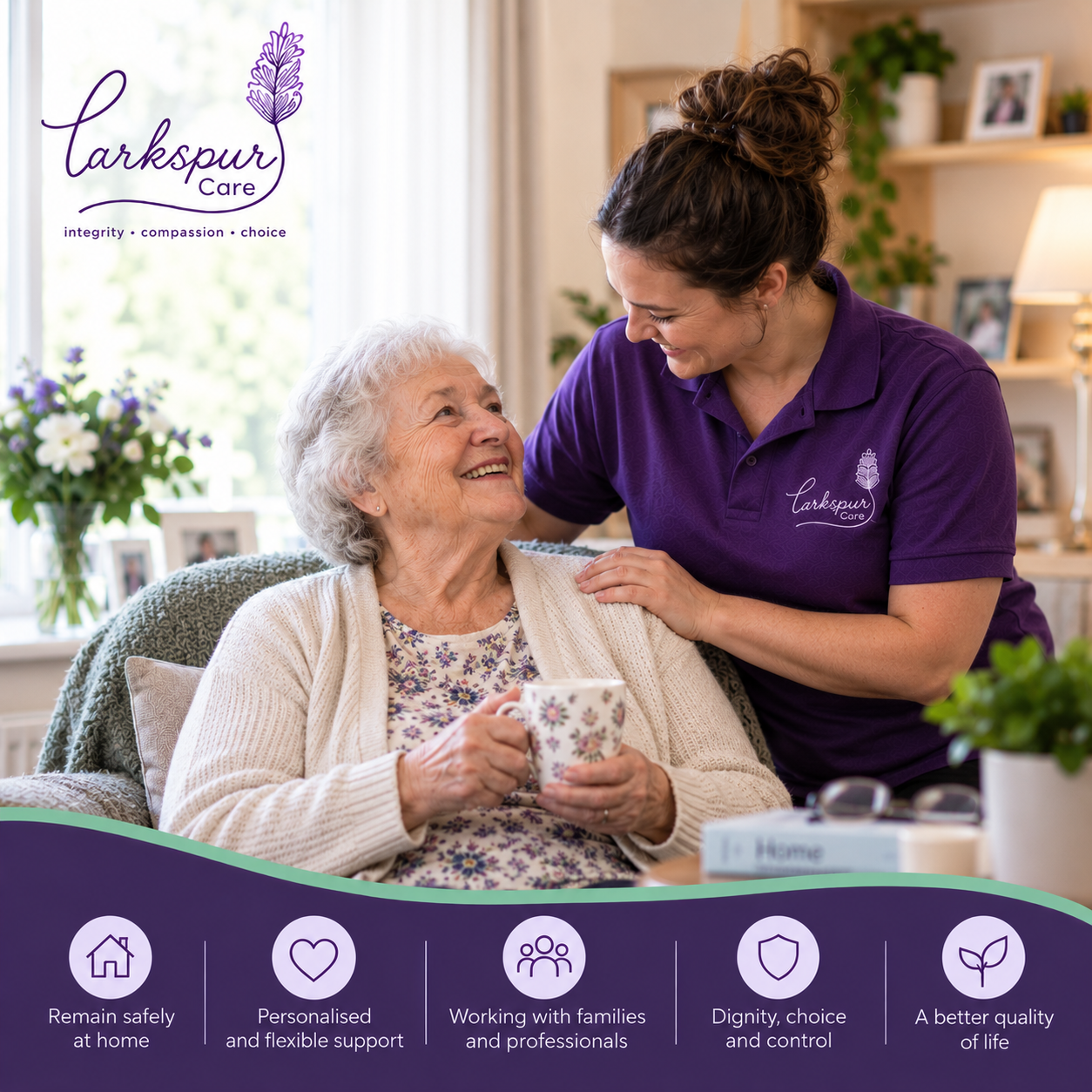 A caregiver in a purple uniform talking to an elderly woman holding a floral mug, sitting in a cozy living room surrounded by family photos and flowers.