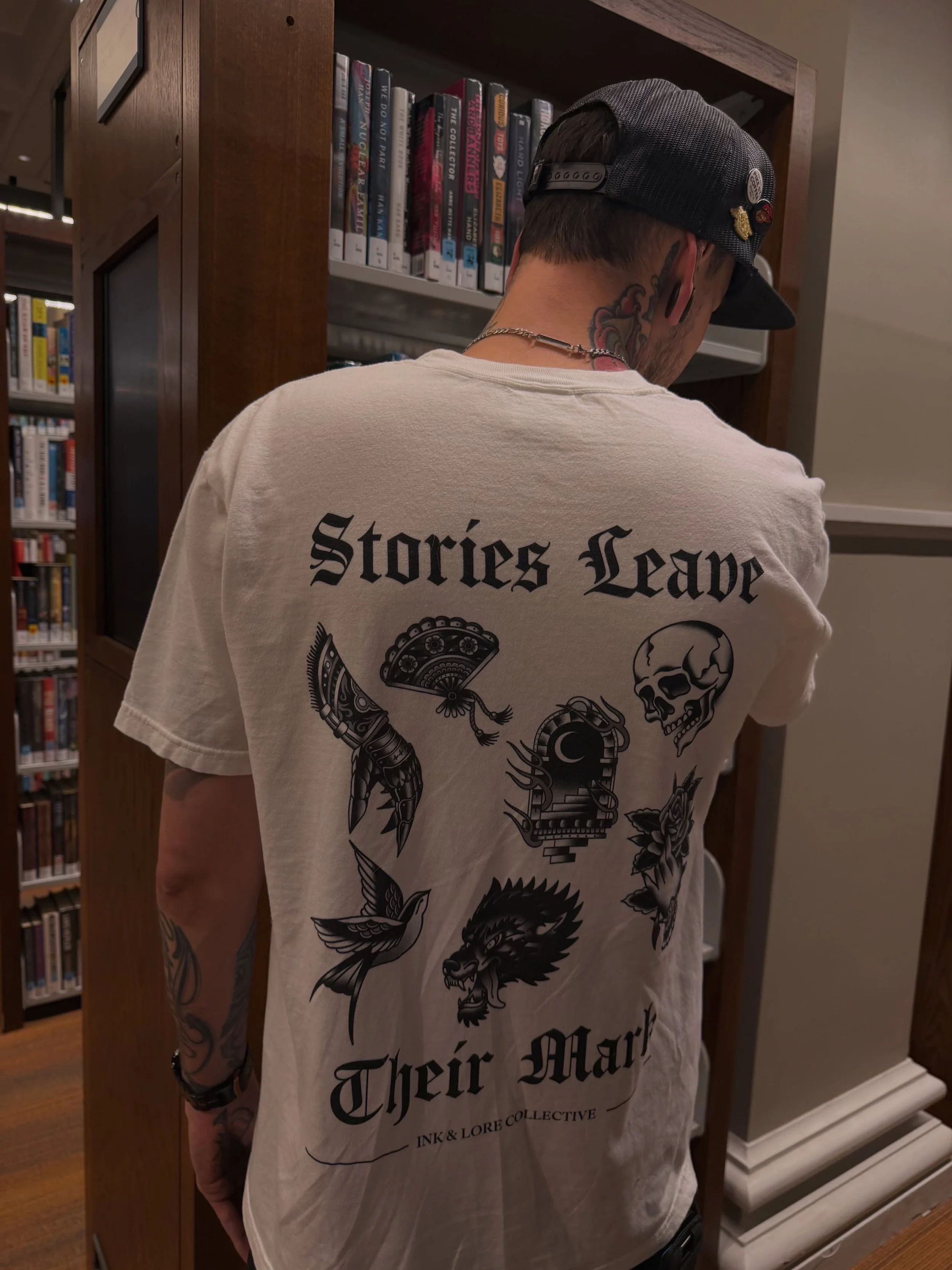 Ink &amp; Lore in its natural habitat. 🖤📚

Surrounded by shelves, lost in a good book, and wearing the reminder that our favorite stories never really leave us&mdash;they leave their mark. Safe to say, this tee belongs in every reader&rsquo;s wardr