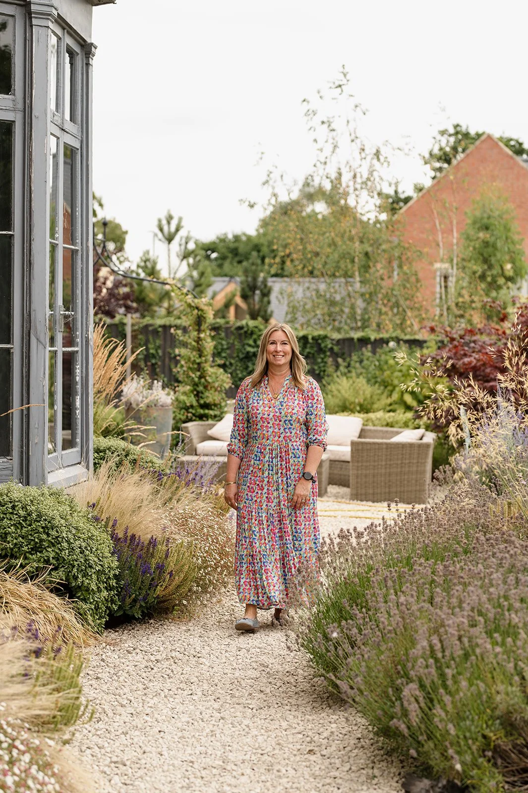 Contemporary British Artist Julie Langford walking through her garden, inspiration for her work exploring emotion and the natural world.