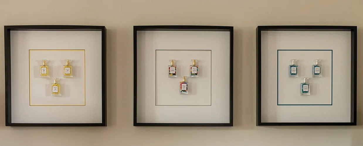 Julie Langford Prescription Collection featuring three framed mixed- media artworks with miniature bottles representing love, hope and Joy.