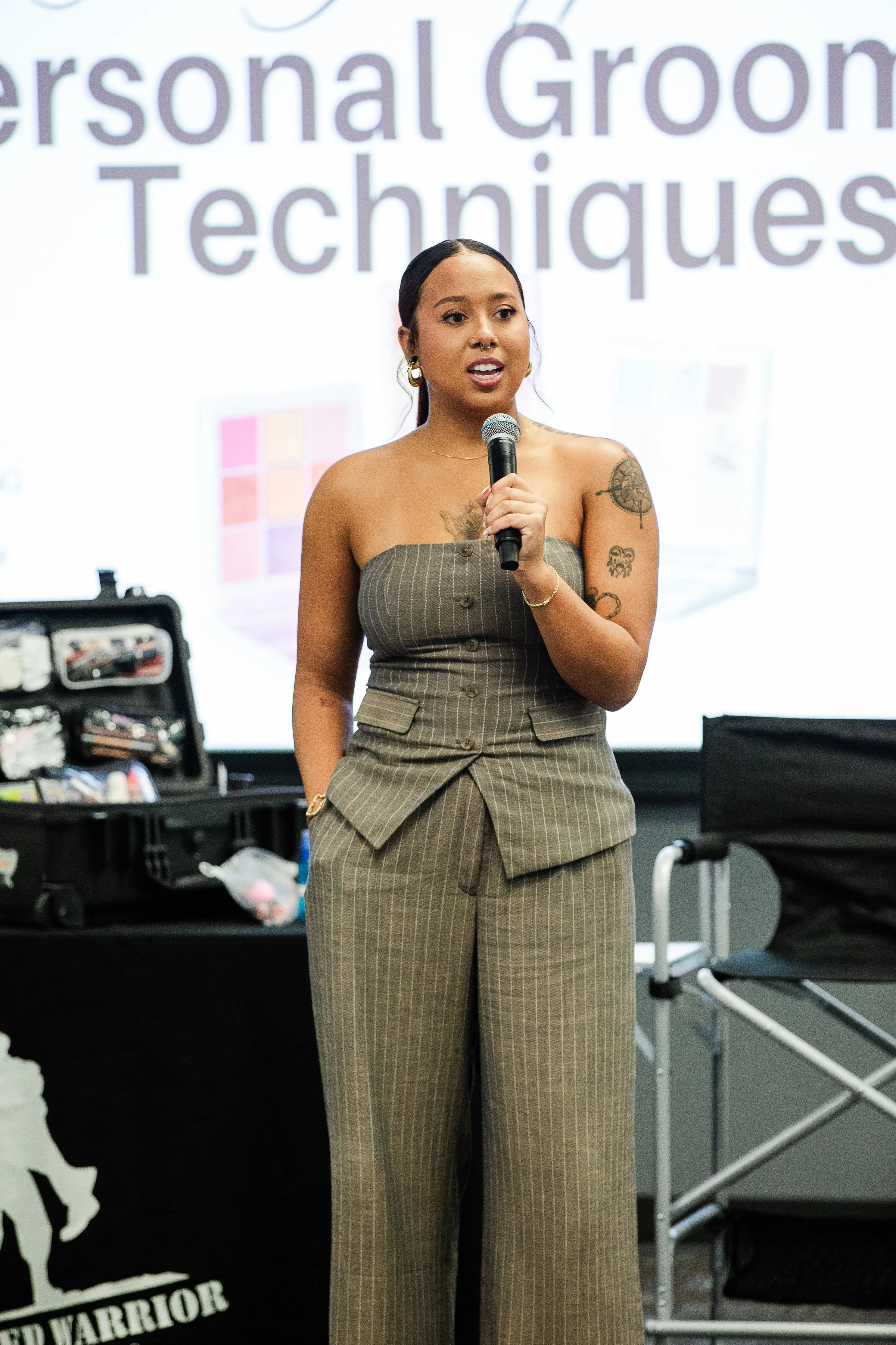 A young woman speaking into a microphone at a presentation.