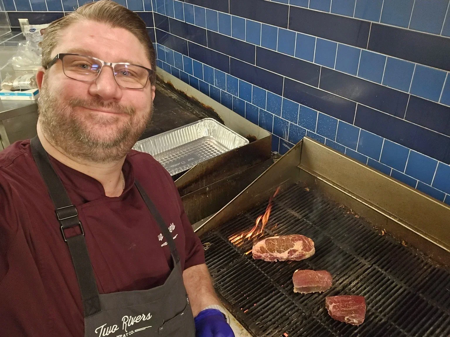 Brian Brozovic grilling steaks during a meat industry event.