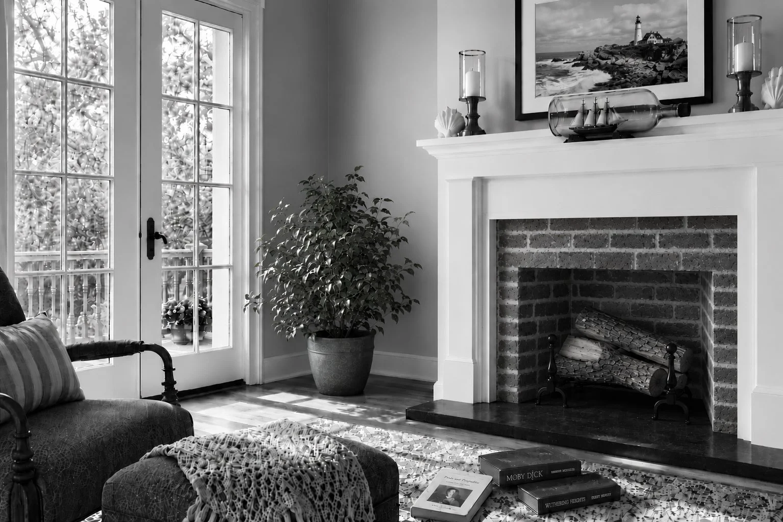Black-and-white photograph of a stone fireplace with stacked logs in a New England interior