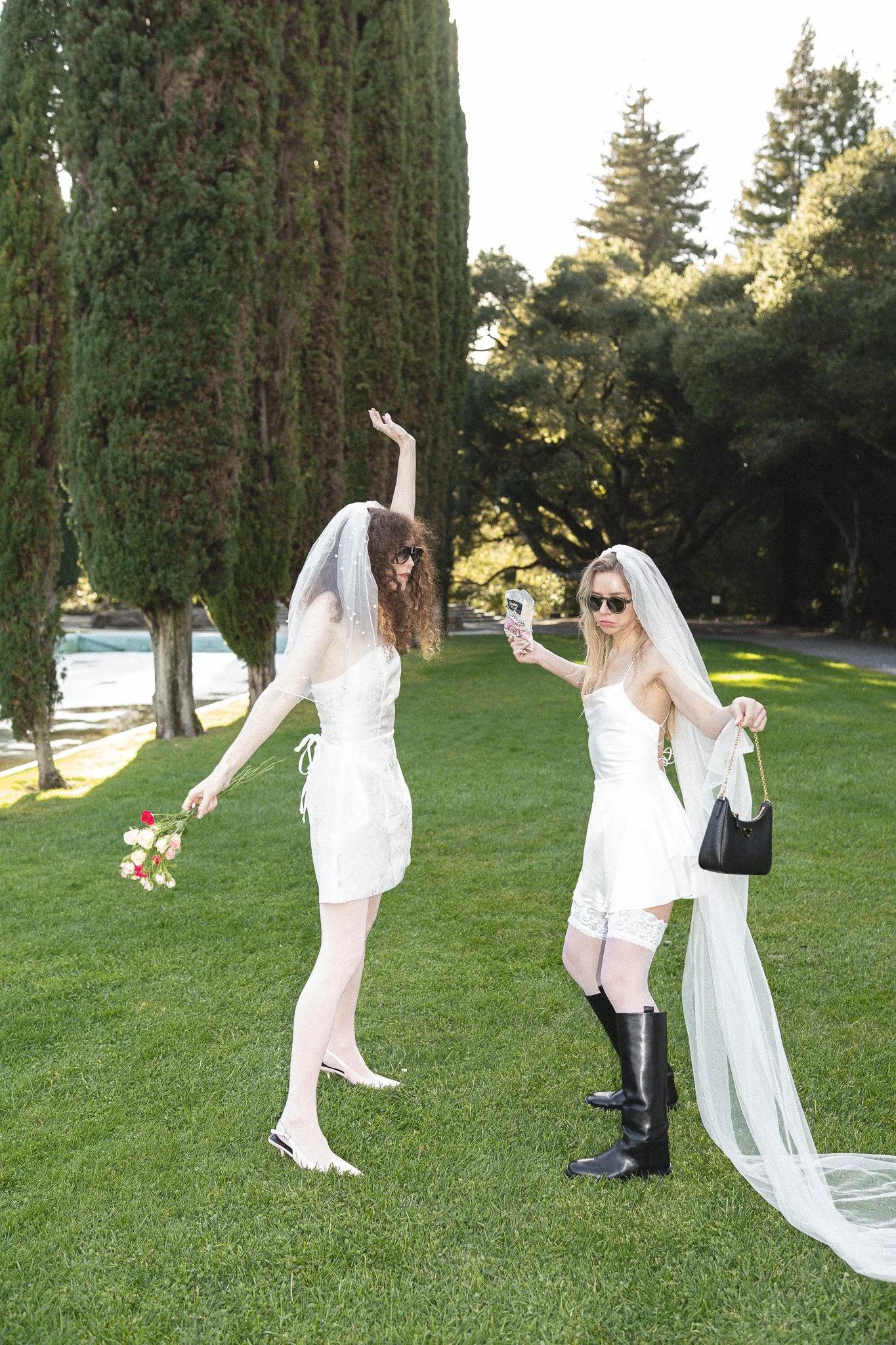 Two brides dancing on the grass. Lesbian elopement photography in Pulgas Water Temple, Woodside.