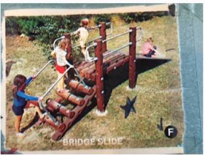 Children playing on a wooden bridge slide in a grassy yard.