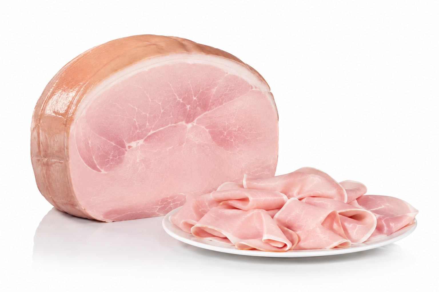 A large chunk of pink ham with a smooth outer layer, and a white plate of thinly sliced ham in front of it on a white background.