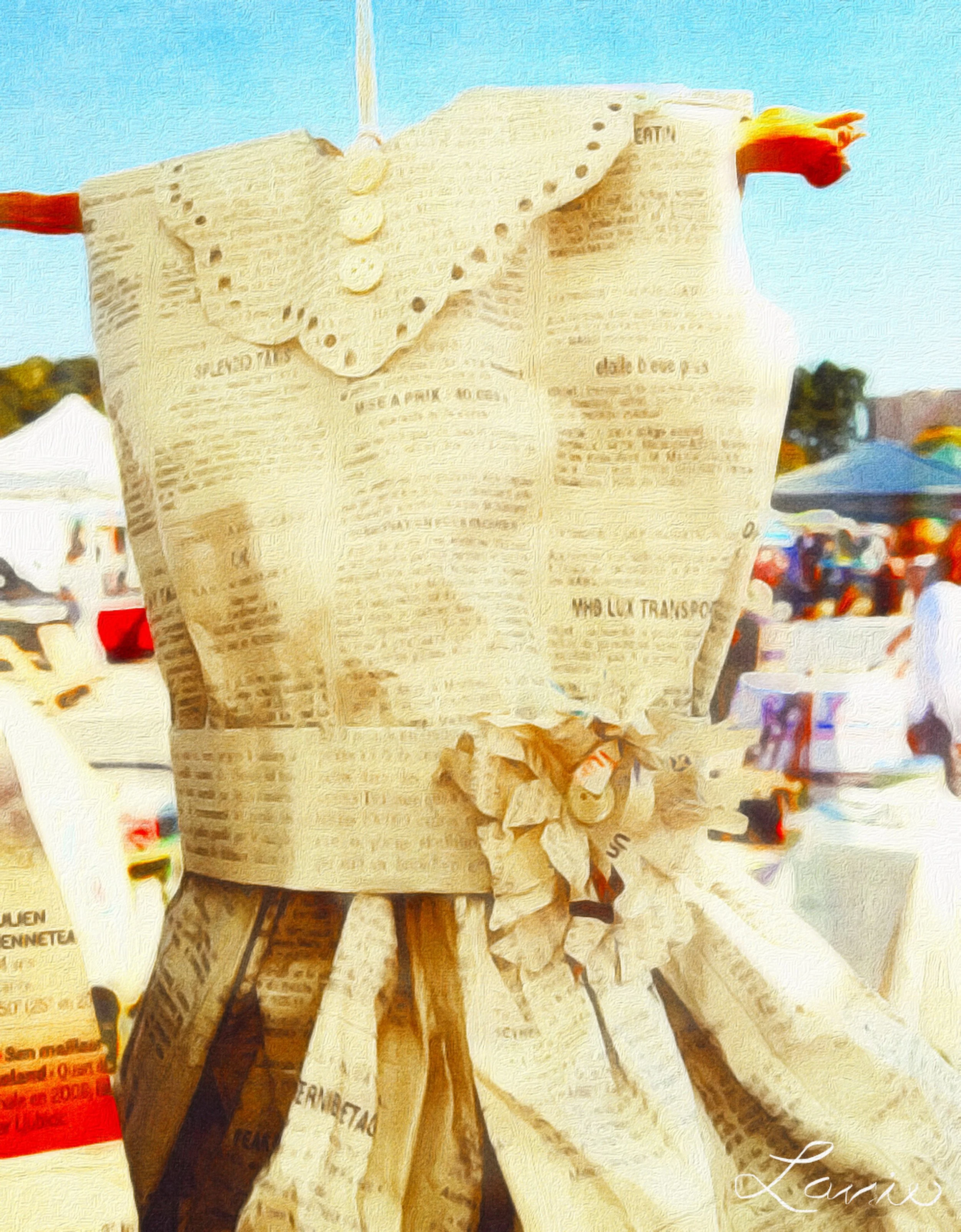 A person holding a peeled Italian newspaper with the word 'Lavoro' at the bottom right corner during daylight with tents and outdoor market in the background.